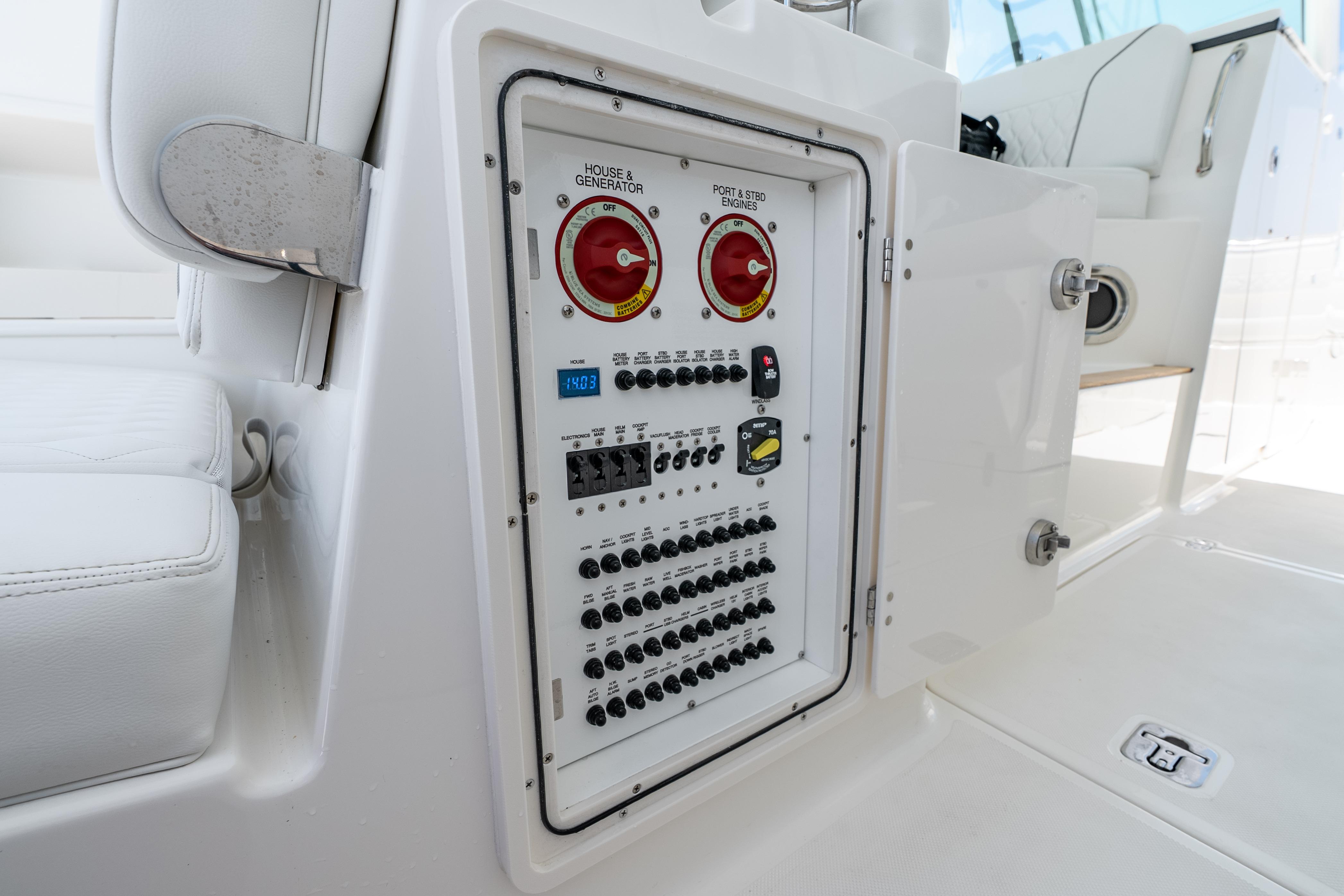 Electrical control panel on 2026 Pursuit DC 326 Dual Console boat, featuring switches and gauges.