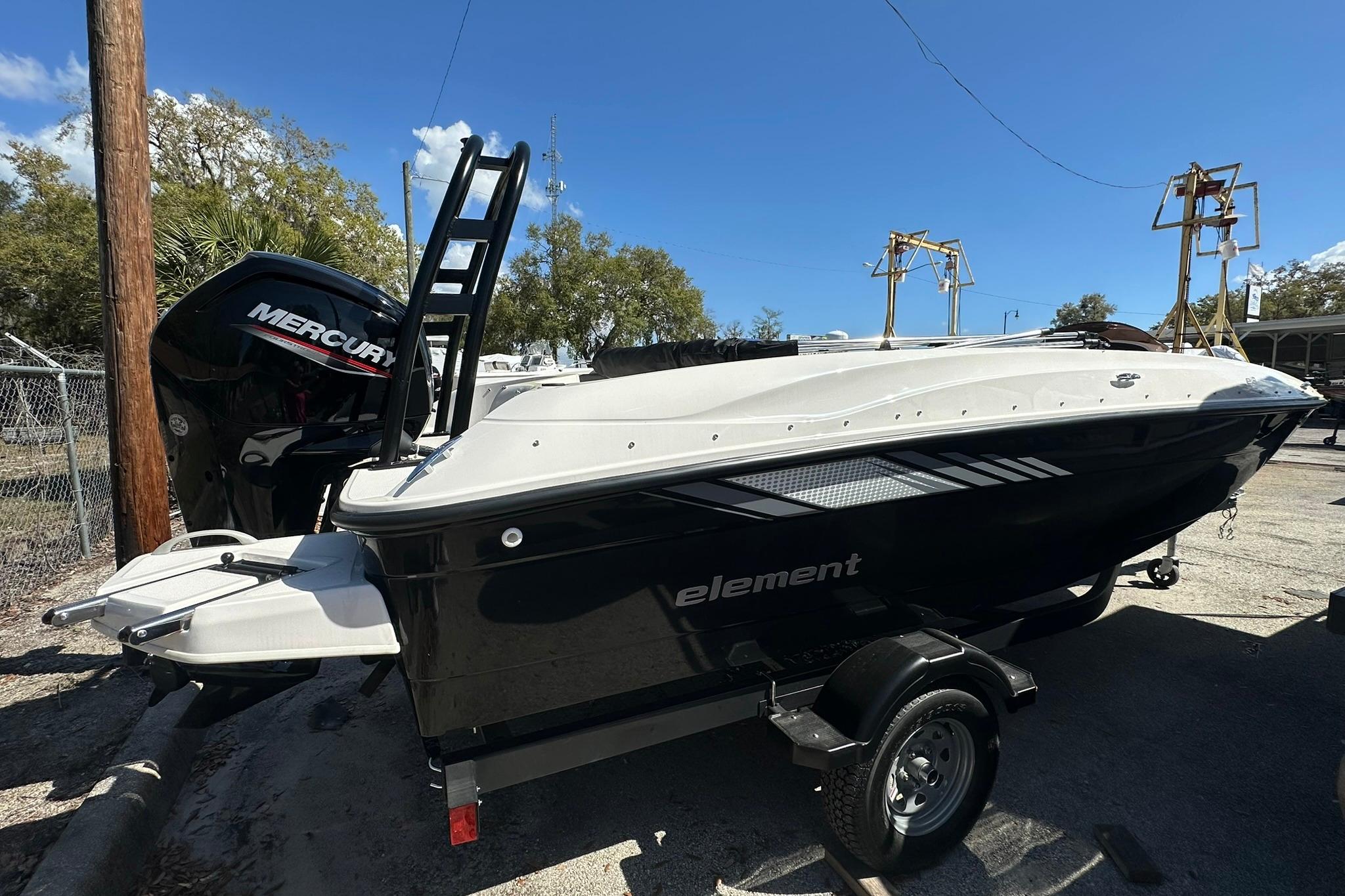 2026 Bayliner Element E18 boat with Mercury engine, parked outdoors on a trailer.