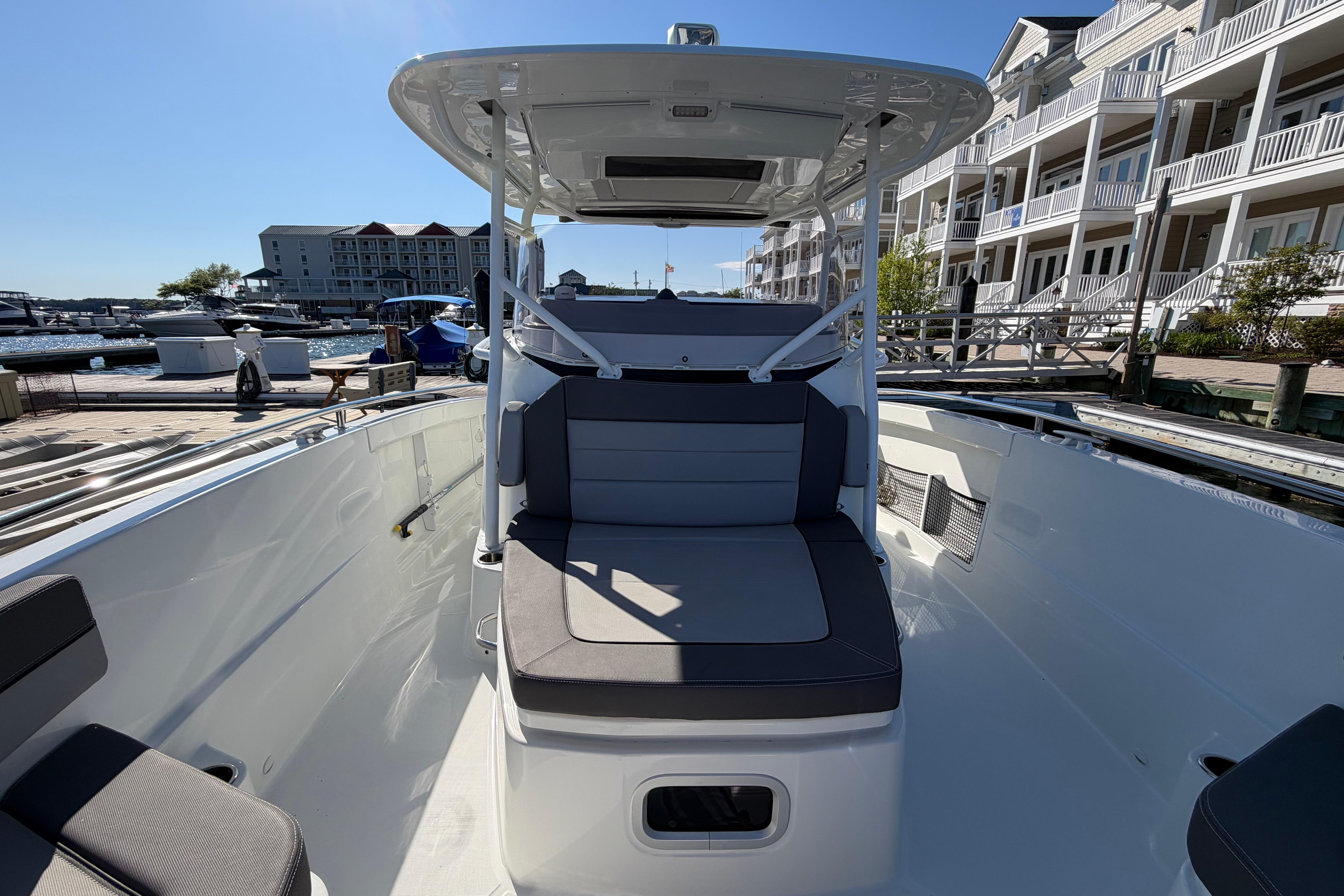 2024 Jeanneau Leader 9.0 CC boat docked at a marina, showcasing sleek seating and modern design.