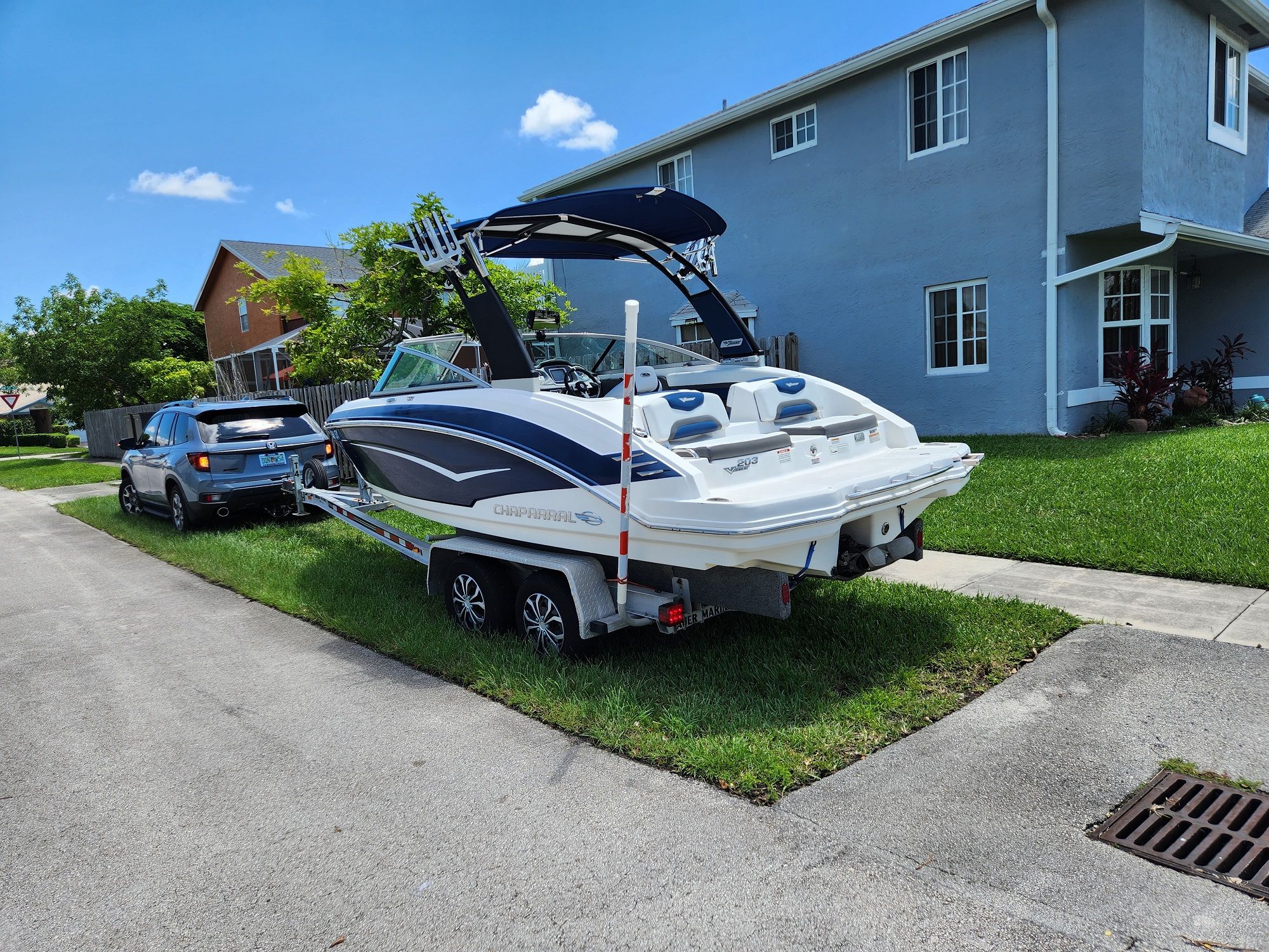 2015 Chaparral 203VR boat on trailer in residential area.