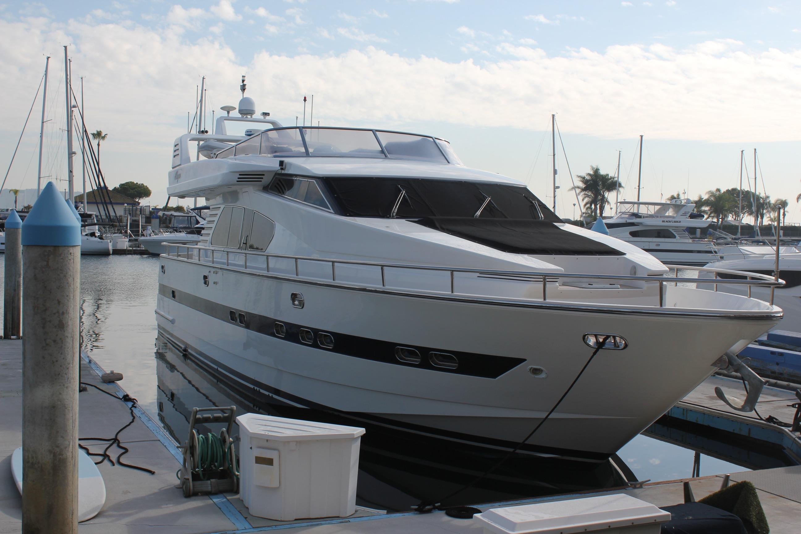 1999 Horizon 70 Motor Yacht docked at marina, surrounded by other boats.