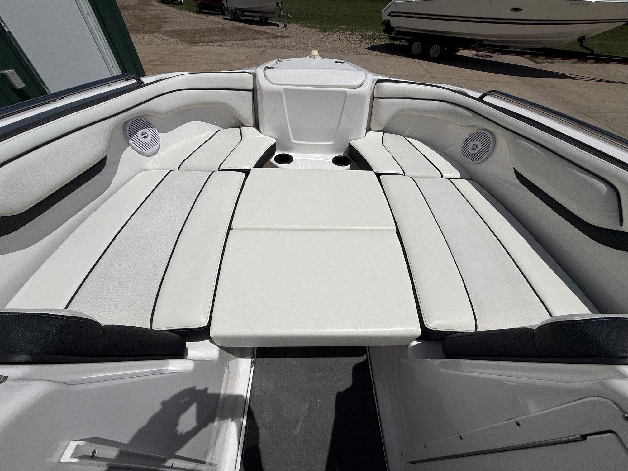 The image shows the interior of a Yamaha SX210 boat with white seating.