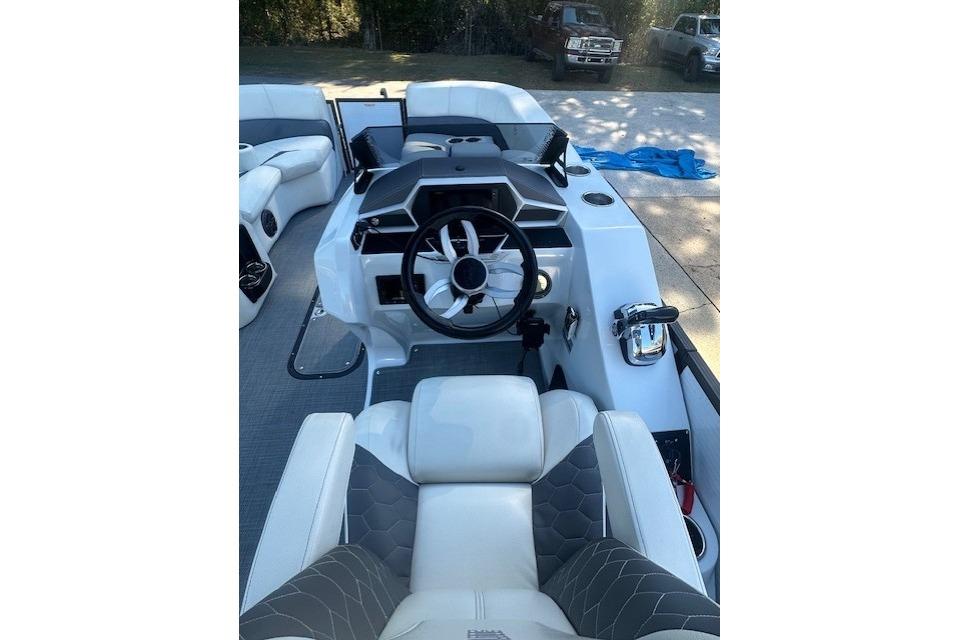 2020 Manitou 25 X-Plode RFW boat interior with modern steering and seating.