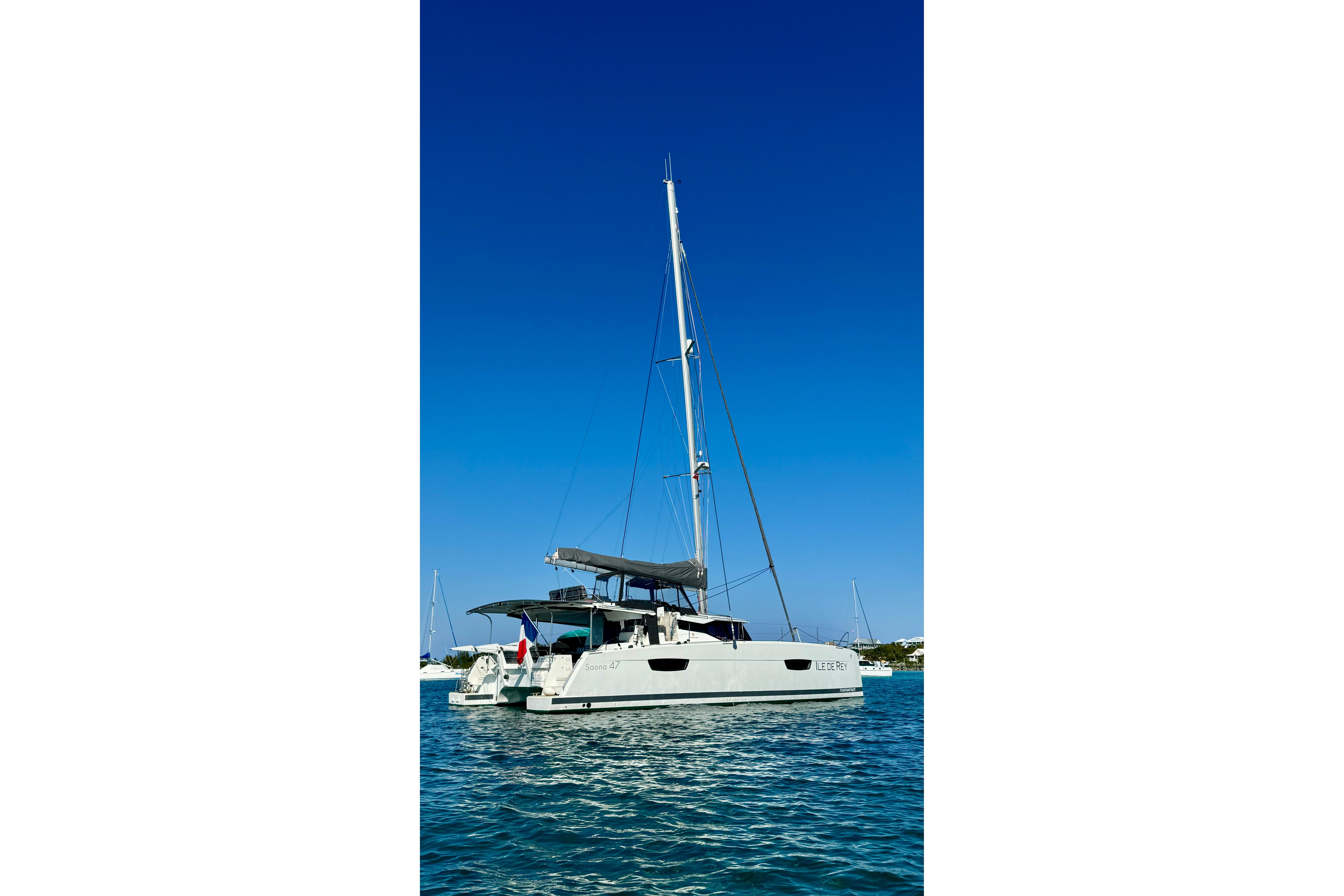 2020 Fountaine Pajot Saona 47 catamaran sailing on clear blue waters.