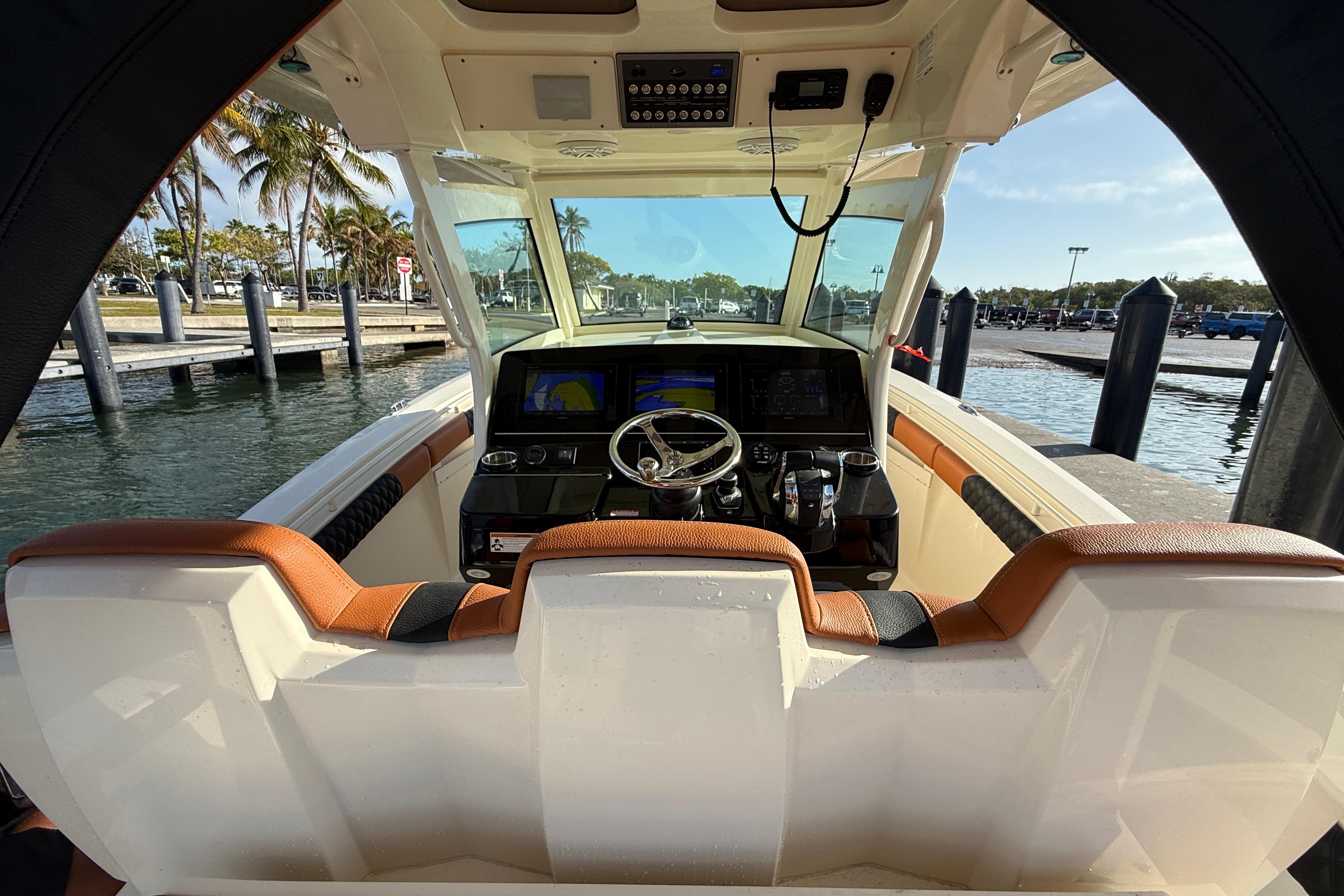 2019 Scout 355 LXF boat cockpit with modern controls and waterfront view.