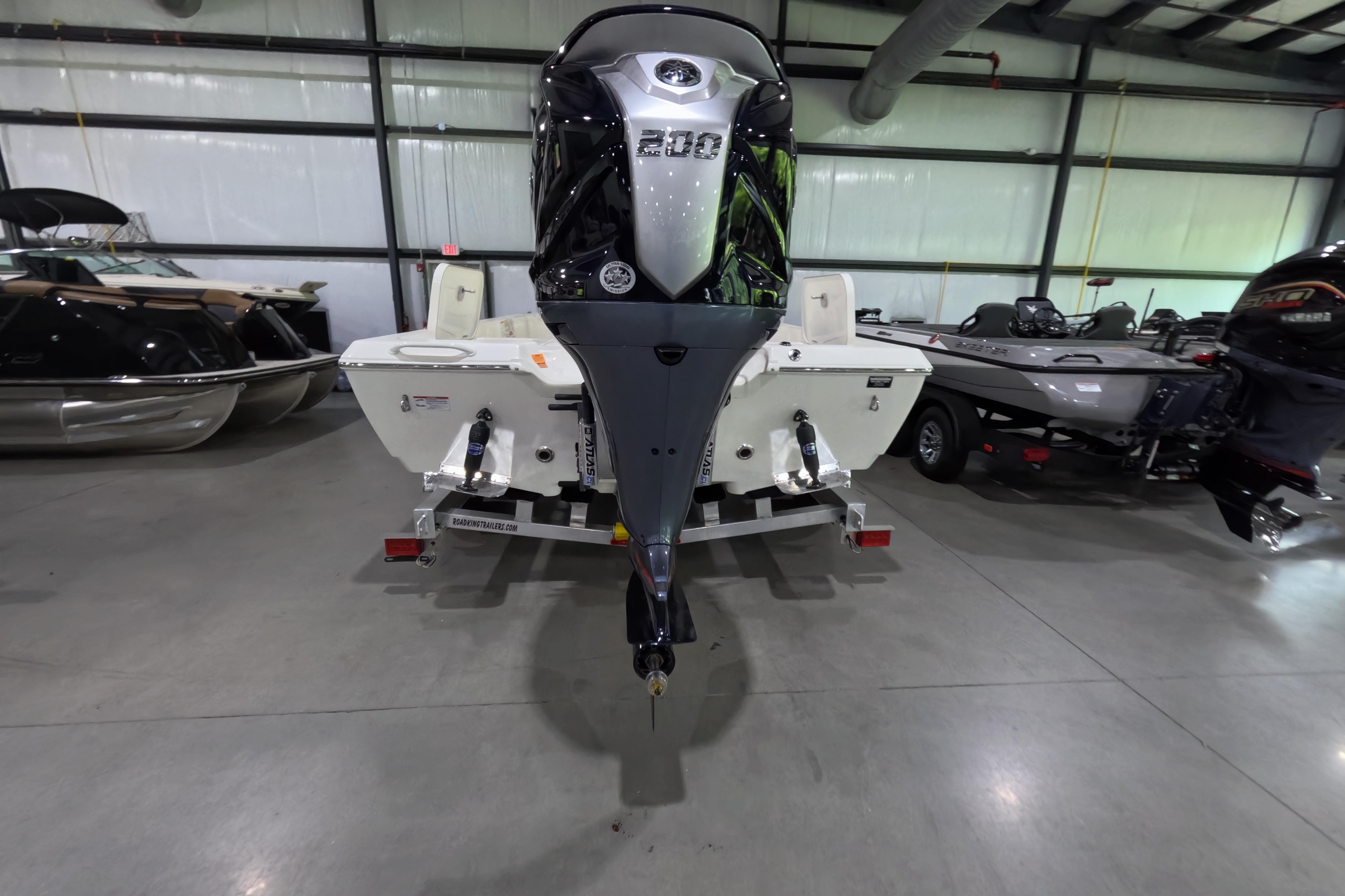 2026 Skeeter SX221 boat with powerful outboard motor in showroom.