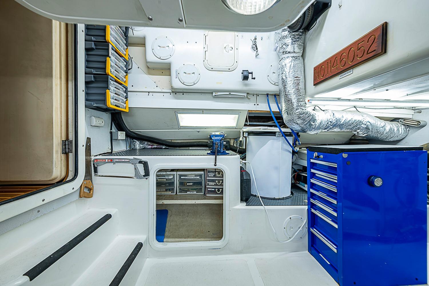 Engine room of 2003 Magna Marine Nova Scotia 47 with tools and storage compartments.