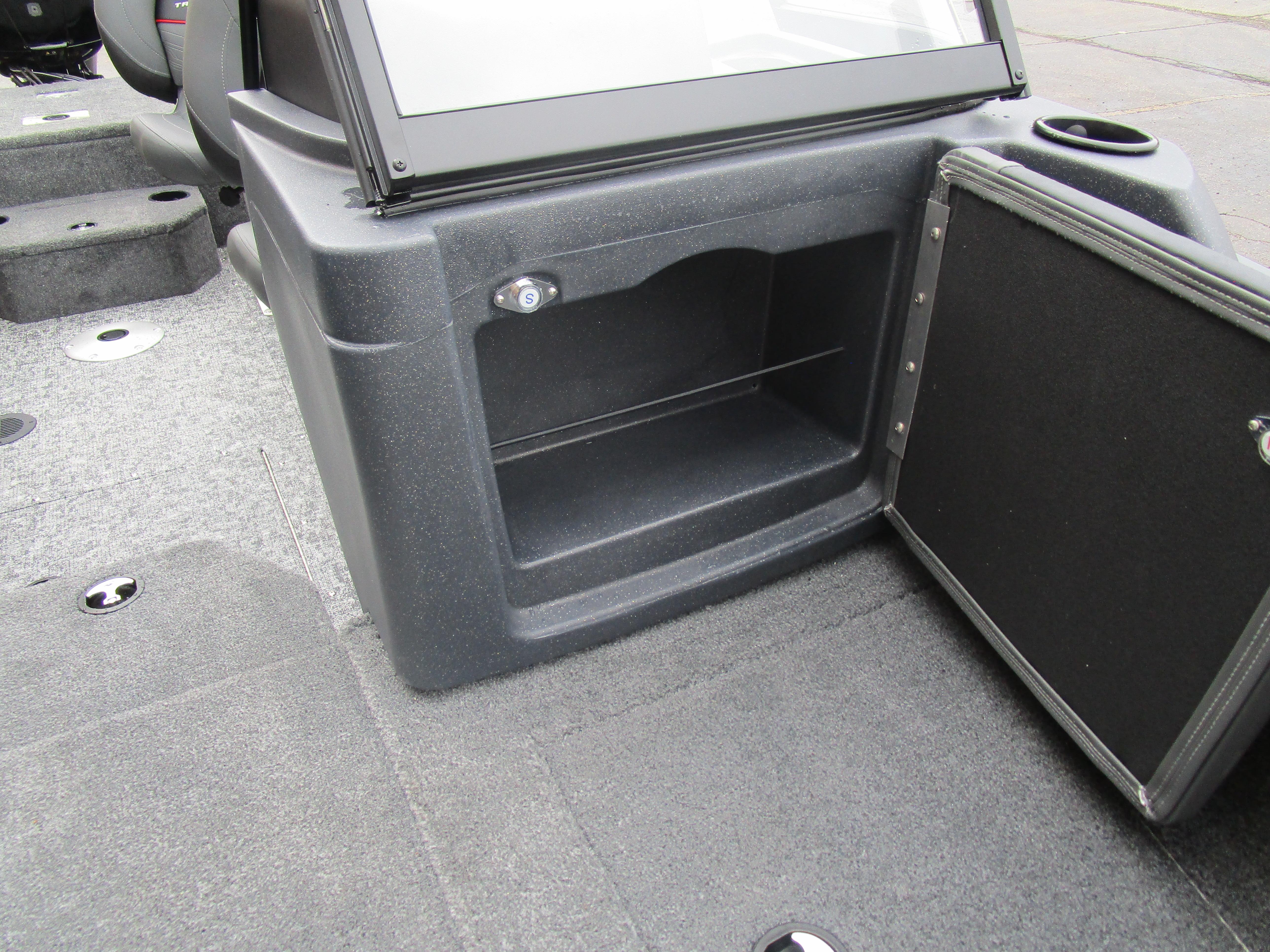 2026 Tracker Targa 18 WT boat interior storage compartment with open door and cup holder.