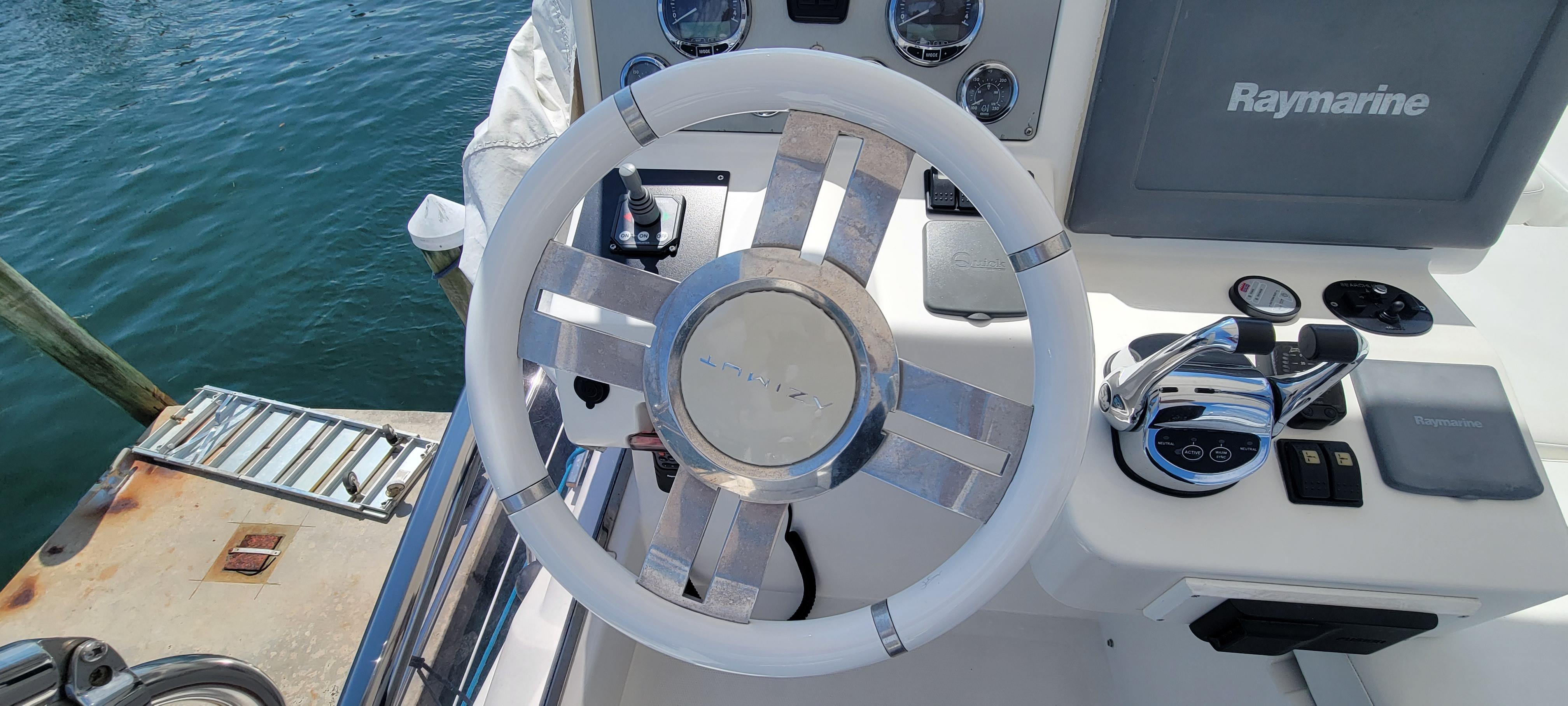 Steering wheel and controls of a 2013 Azimut 45 Flybridge yacht.