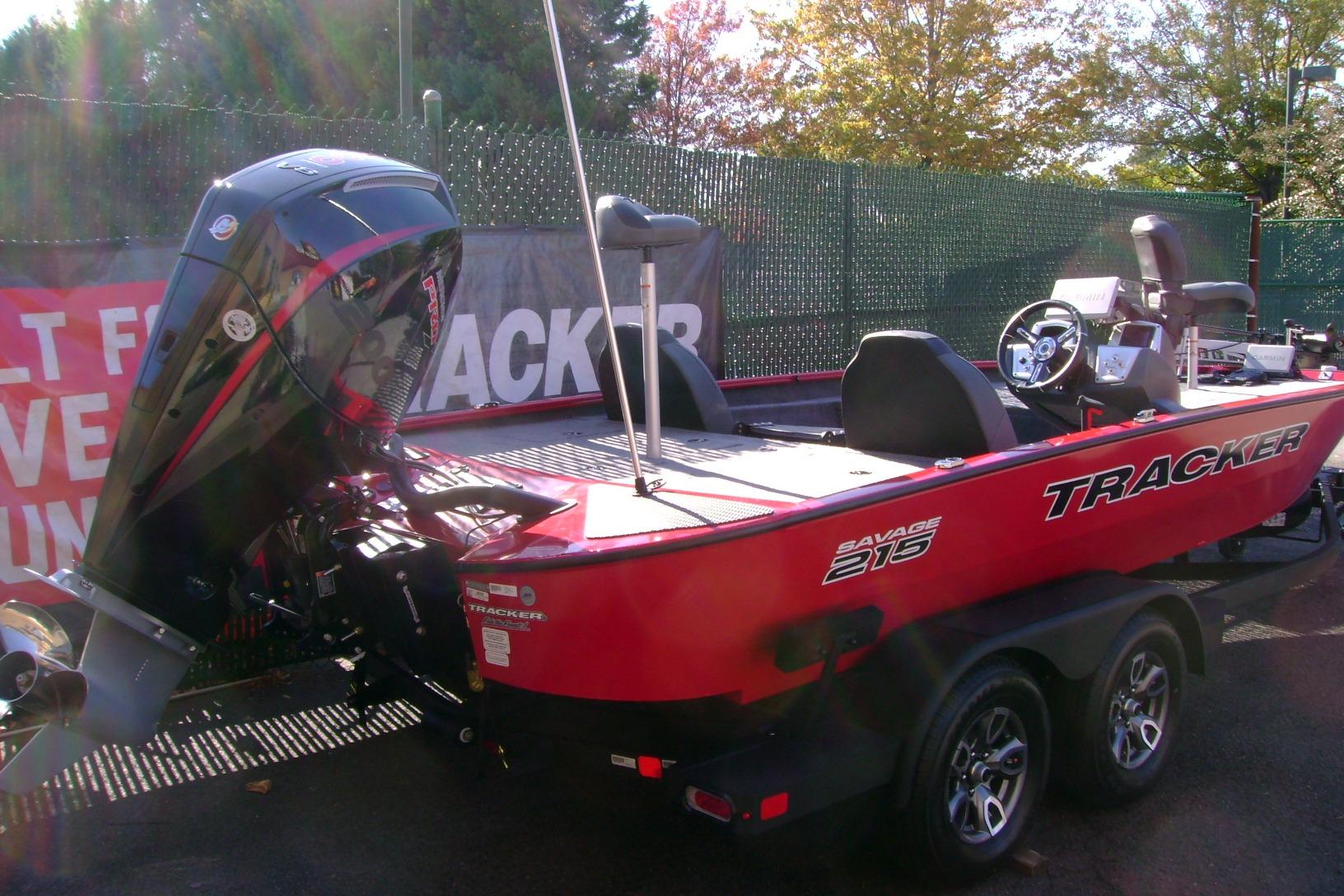 2026 Tracker Savage 215 boat, red exterior, displayed outdoors with motor and trailer.