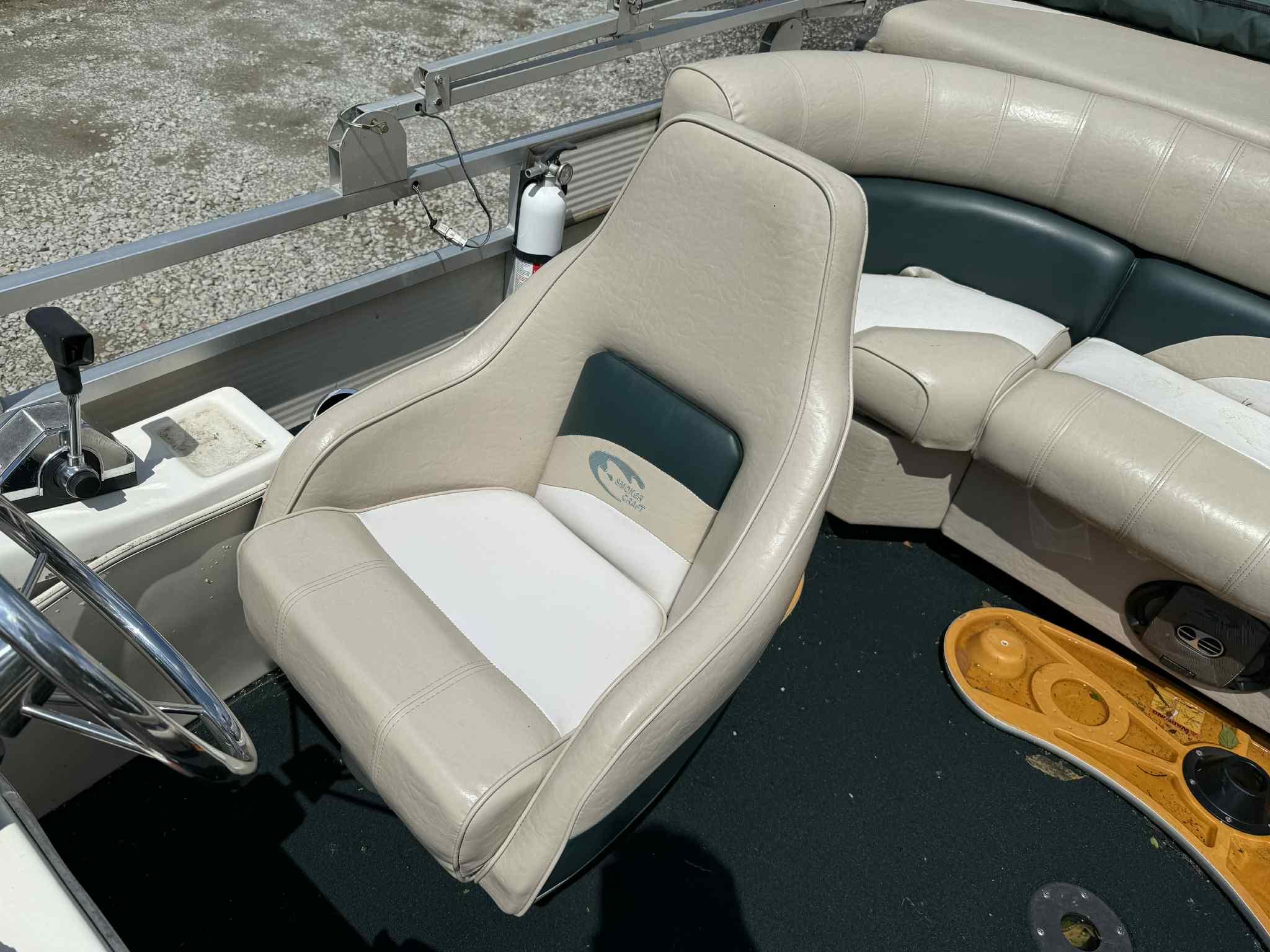 1999 Smoker Craft 8526 Pleasure Isle I/O boat interior with beige seating and steering wheel.