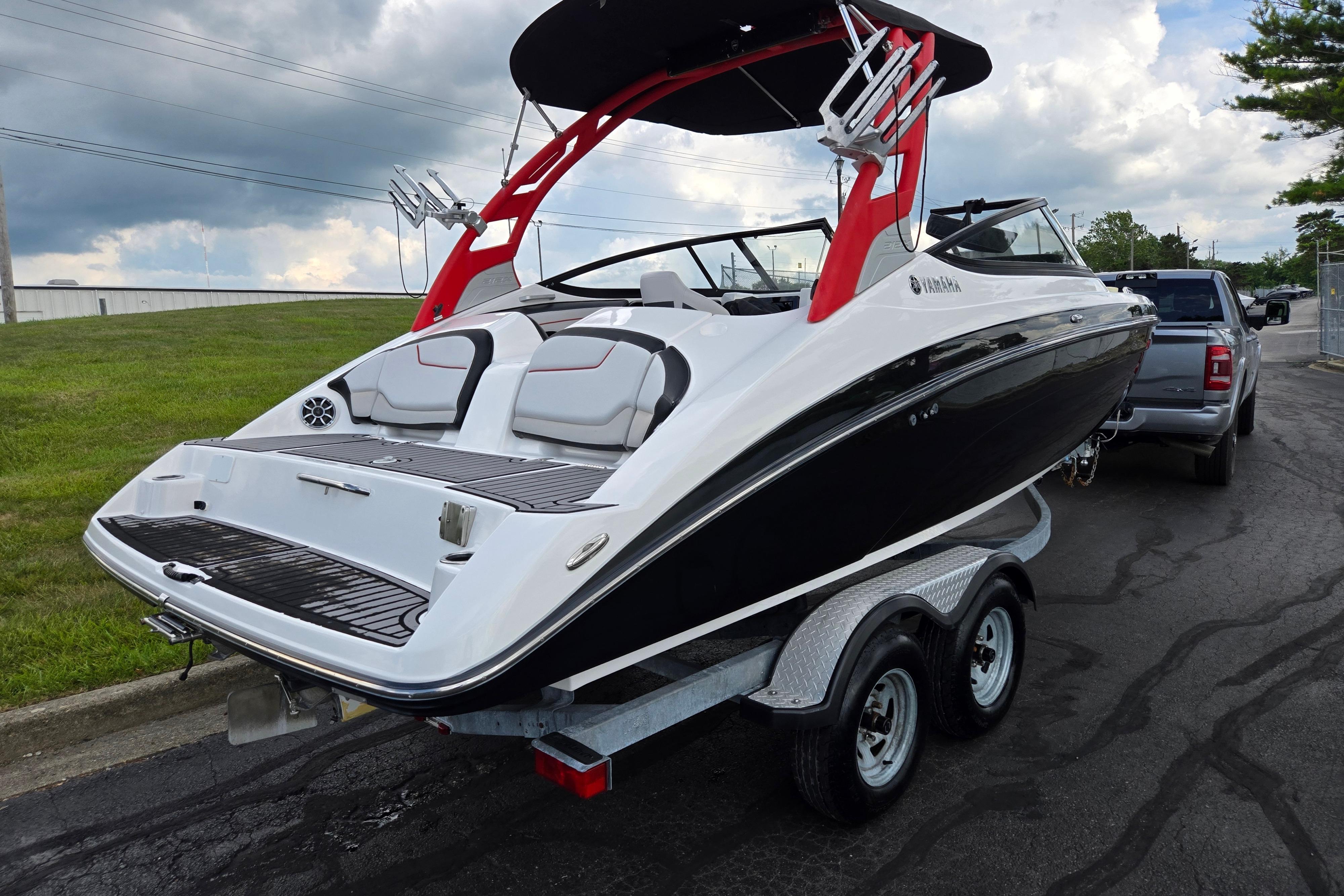 2018 Yamaha Boats 212X on trailer, featuring sleek design and vibrant red accents.