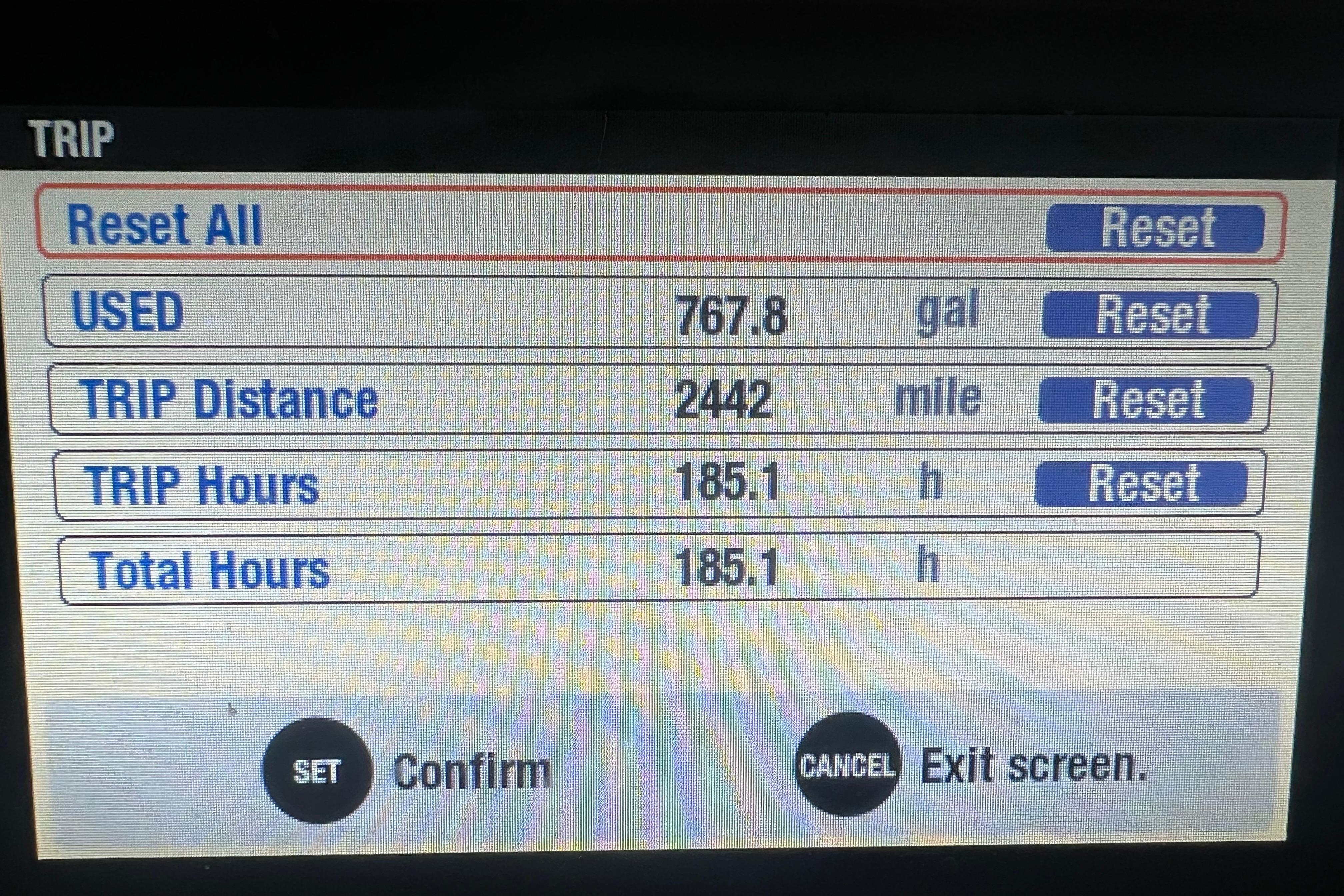Display screen showing trip data: 767.8 gallons used, 2442 miles traveled, 185.1 hours logged.
