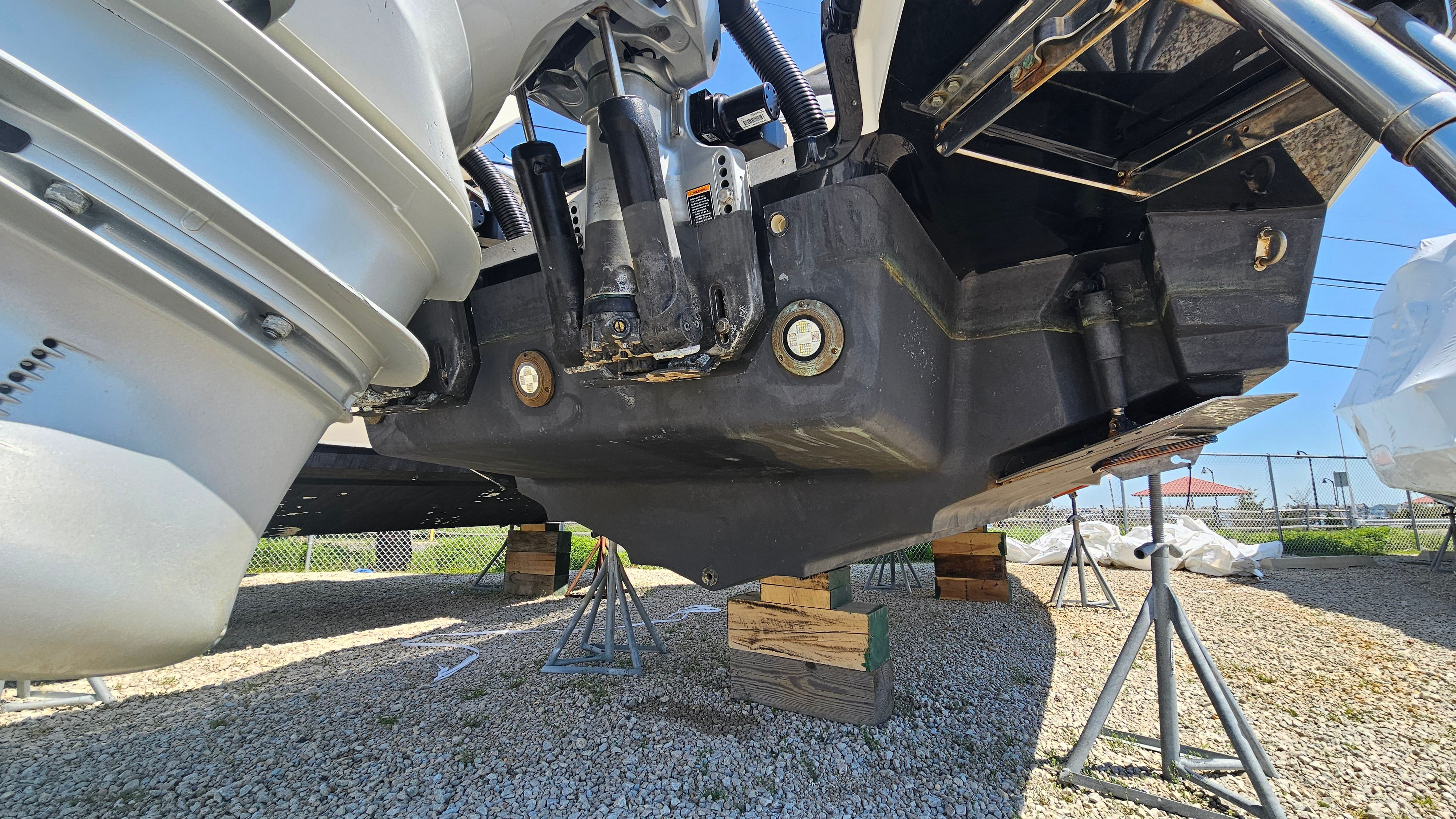 Underside of a 2023 Sea Ray SLX 310 Outboard on stands.
