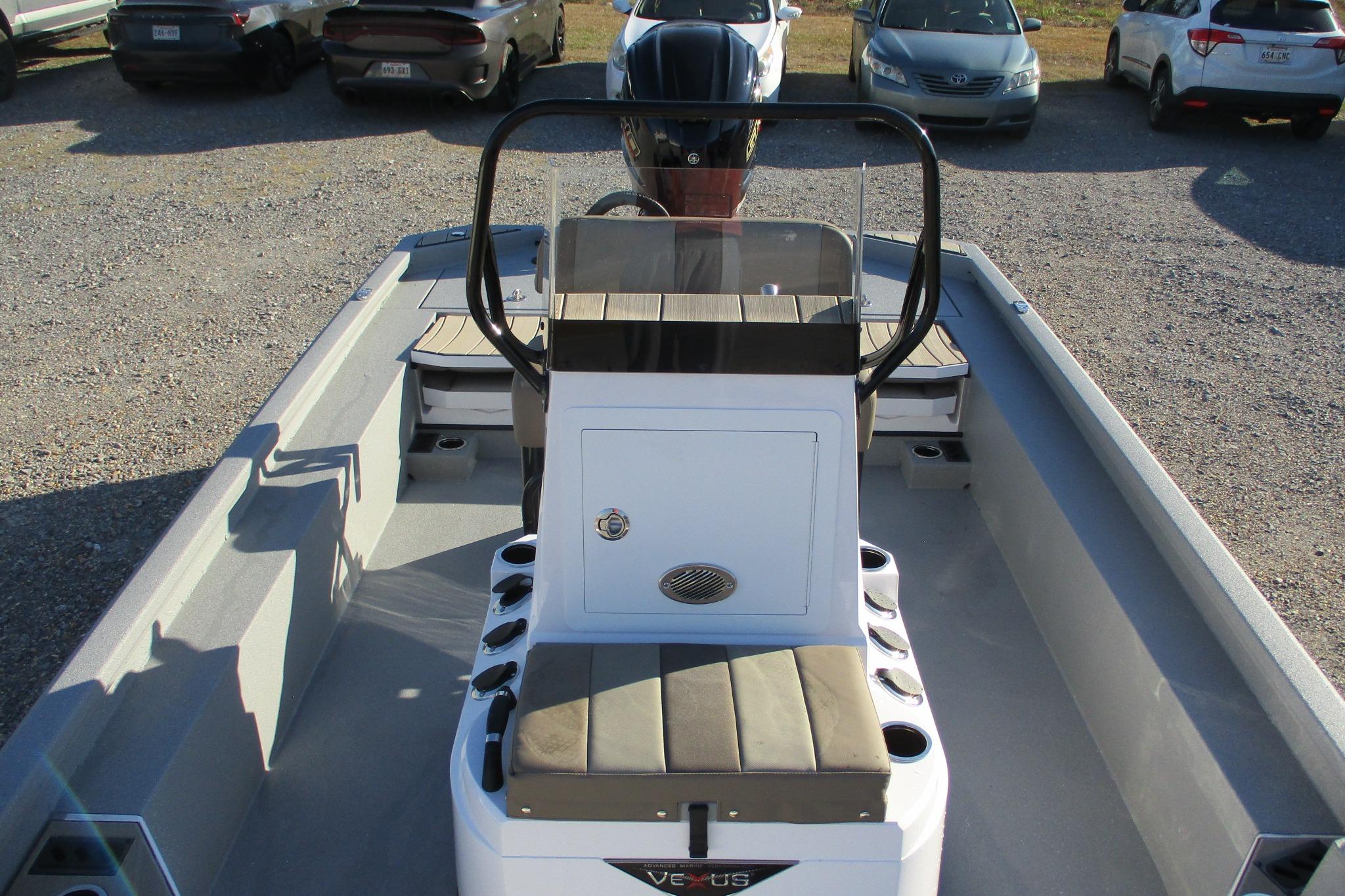 2026 Vexus ACX2210 boat interior with seating and console, parked in a lot.