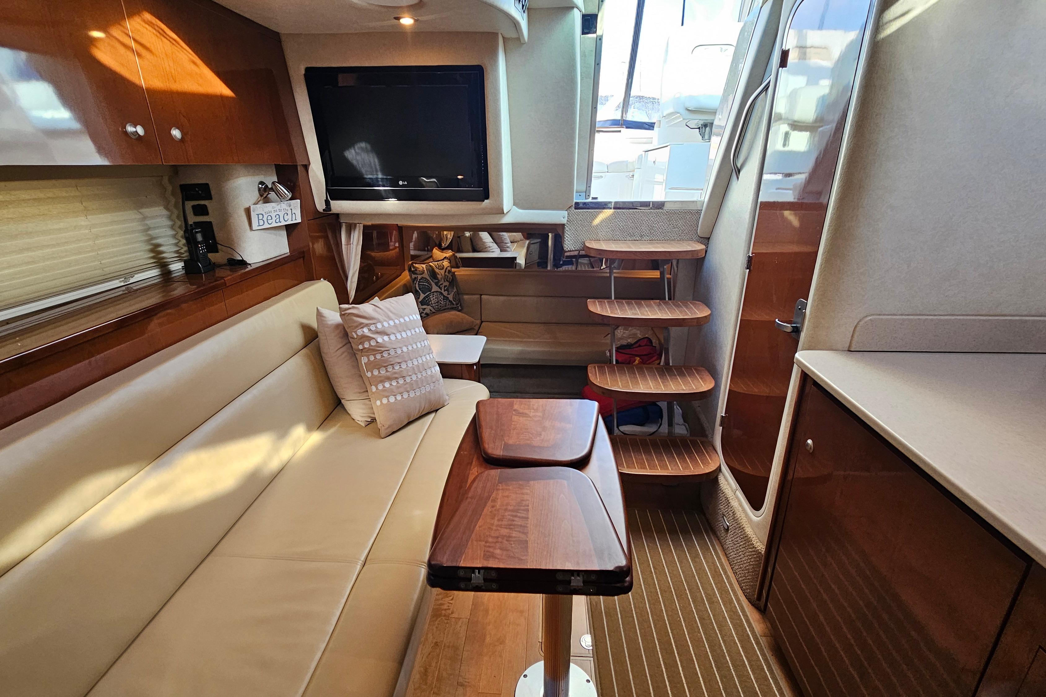 Luxurious interior of 2008 Sea Ray Sundancer 350 yacht with elegant seating and wooden accents.