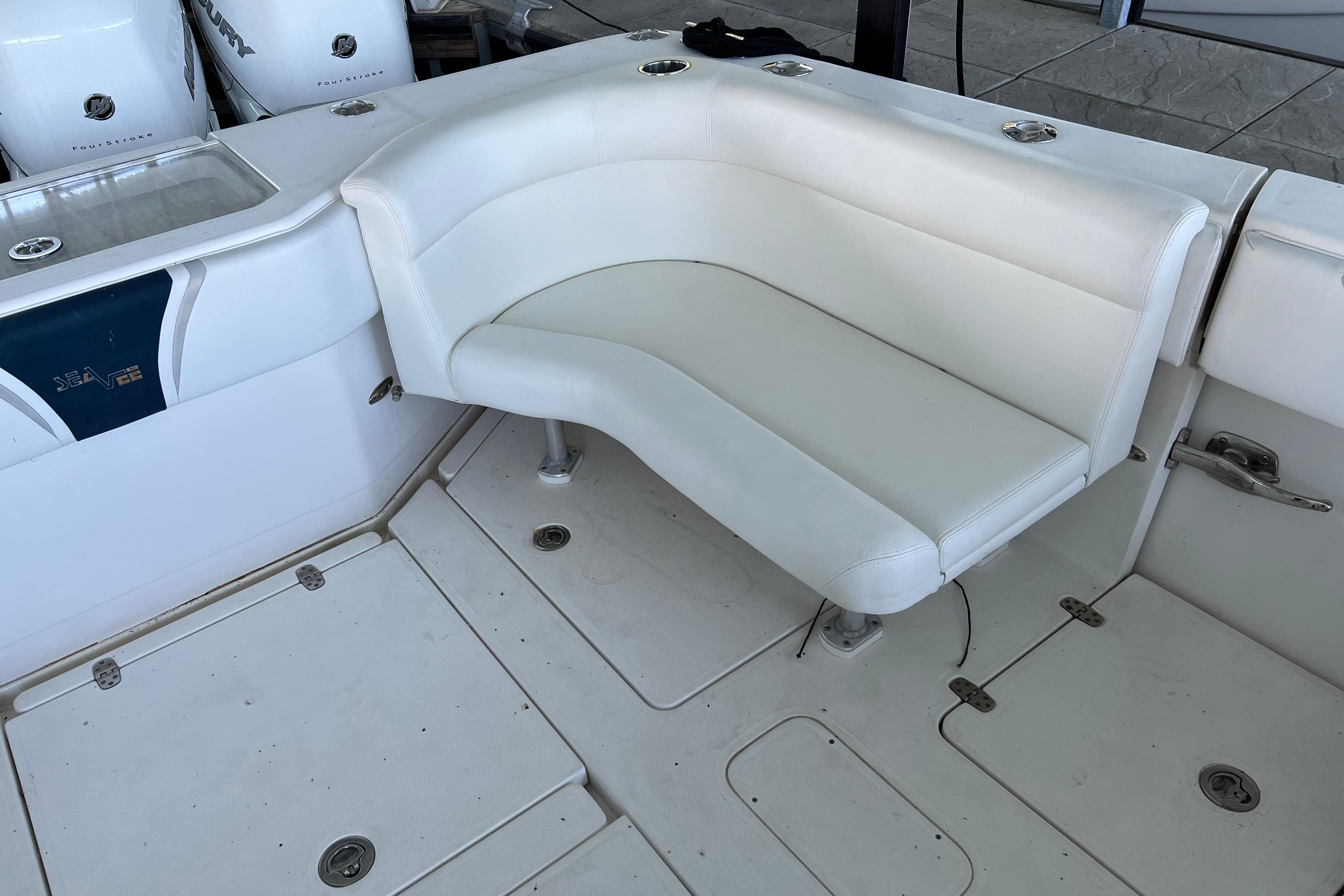 2008 SeaVee 39 boat with white cushioned seating and Mercury outboard engines.