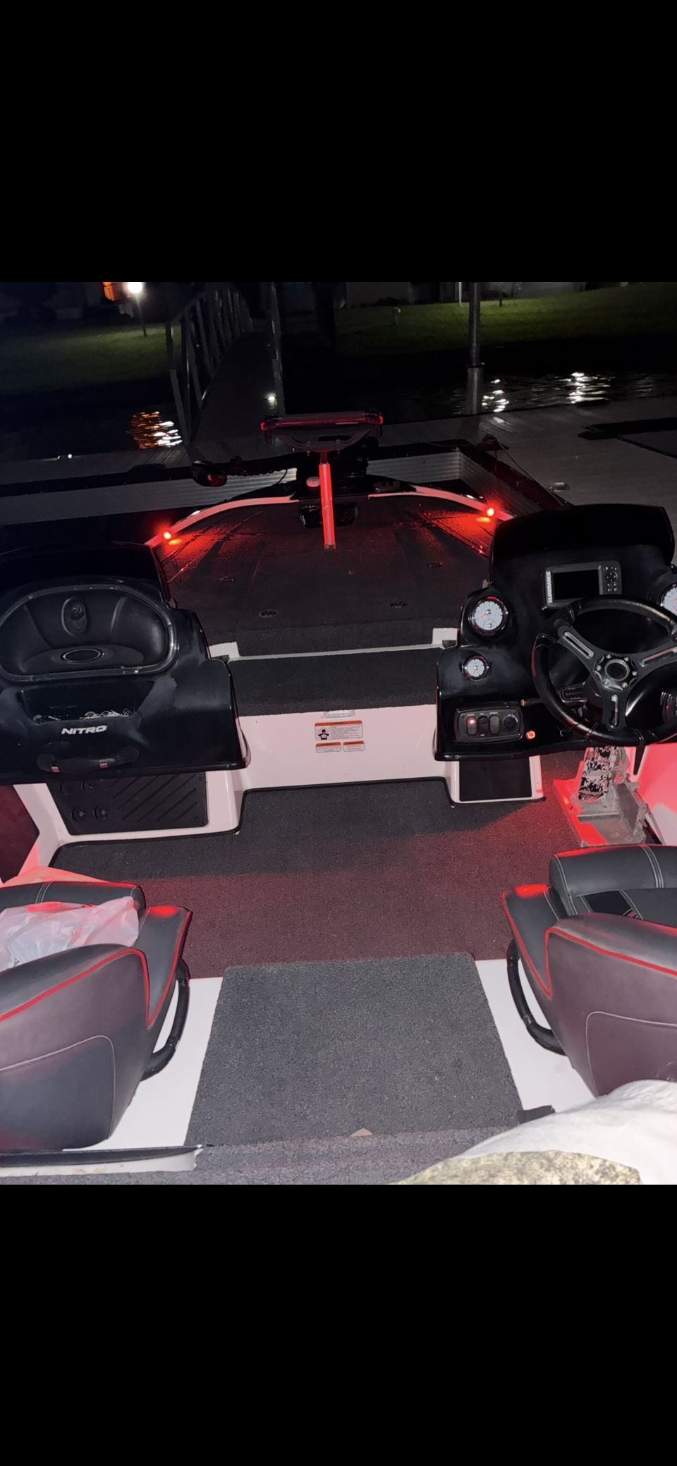 Interior of a Nitro Z18 boat with red lights and two seats.