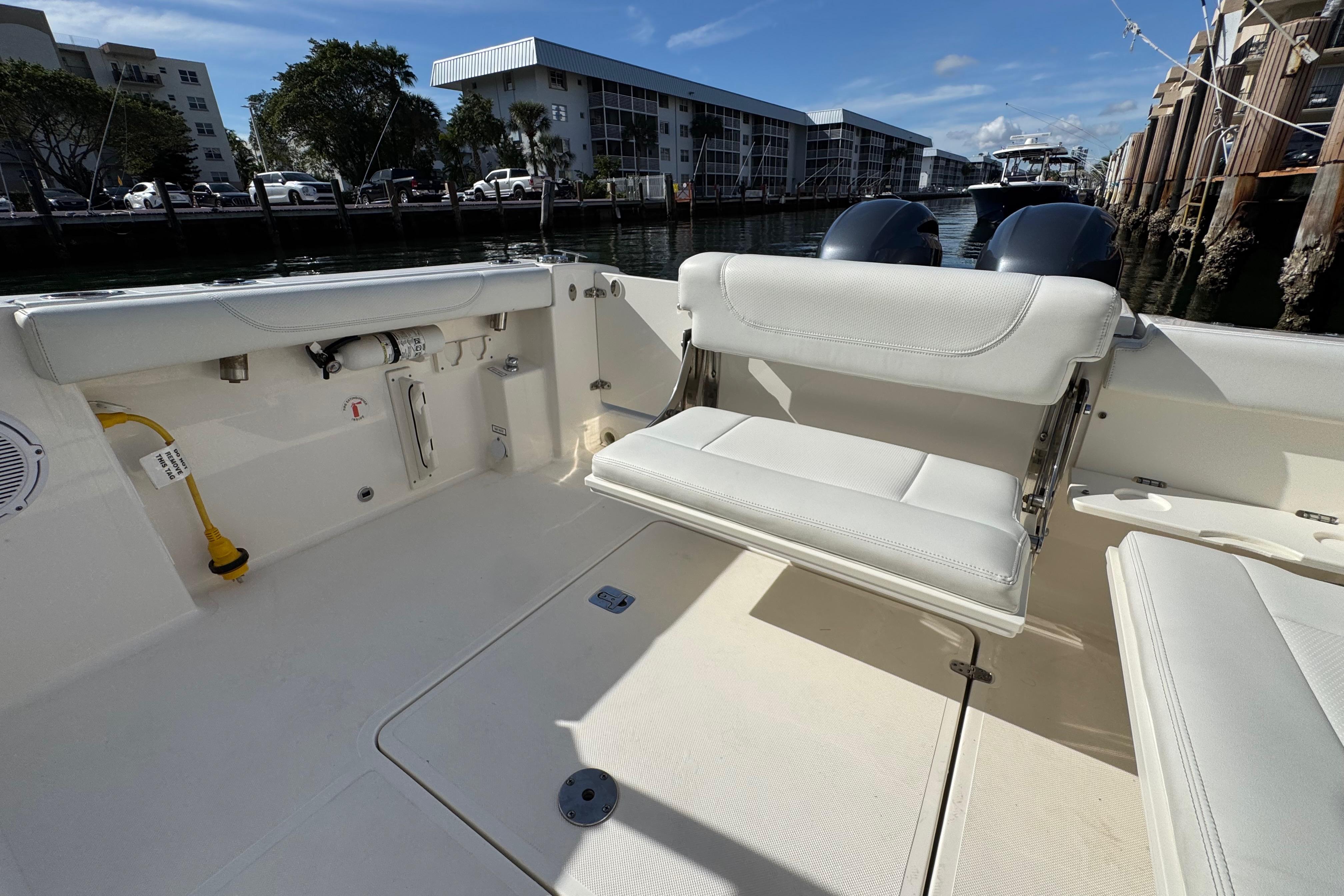 2022 Pursuit DC 266 Dual Console boat interior with seating and dockside view.