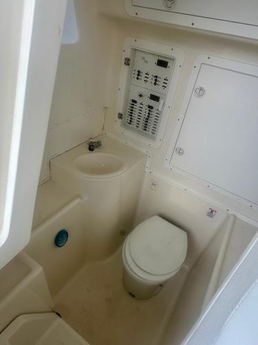 2008 SeaVee 390B boat bathroom with toilet and control panel.