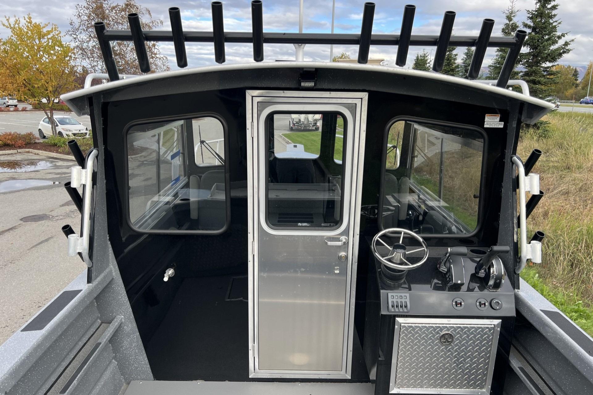 2024 Spartan 220 Maximus boat cockpit with steering wheel and control panel.