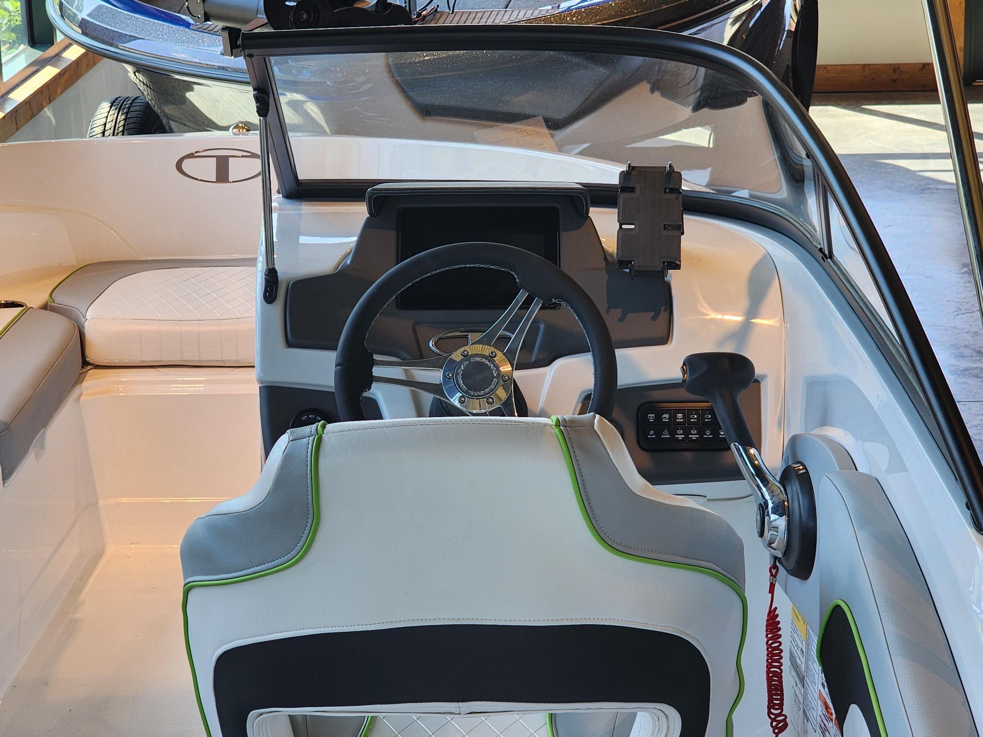 2024 Tahoe 210 Si boat interior with steering wheel and seating.