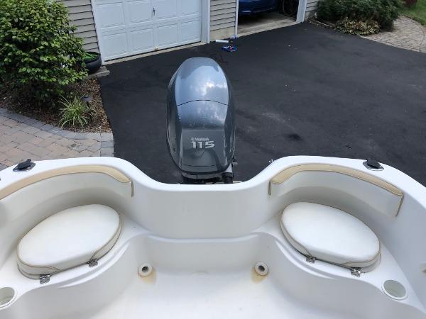 2003 Wellcraft 180 Fisherman boat with Yamaha 115 engine in driveway.