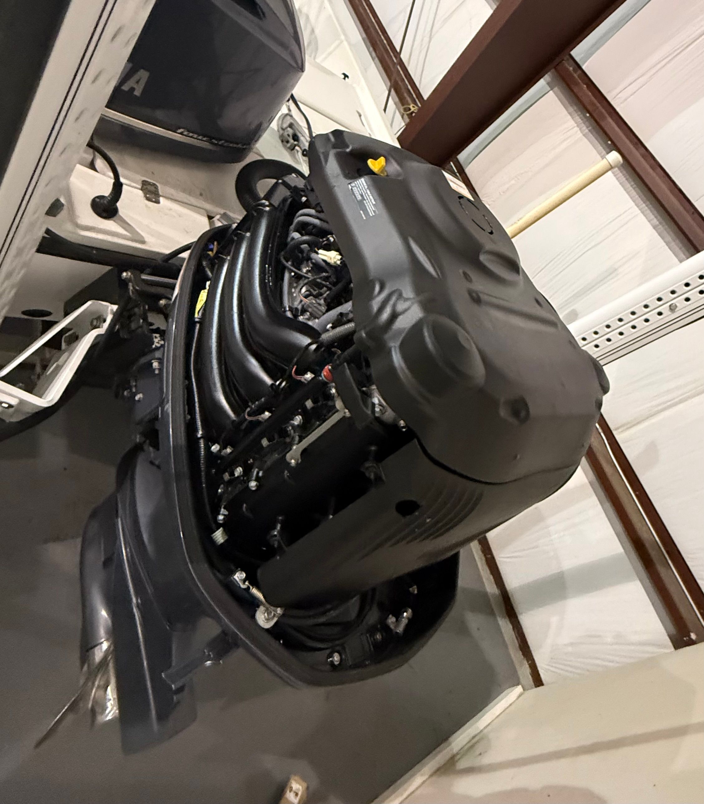 An outboard motor in a storage facility, mounted on a boat.