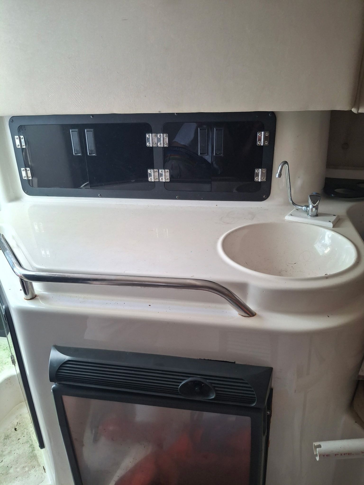 Interior of a 1995 Fountain 31 SFC with a sink and storage area.