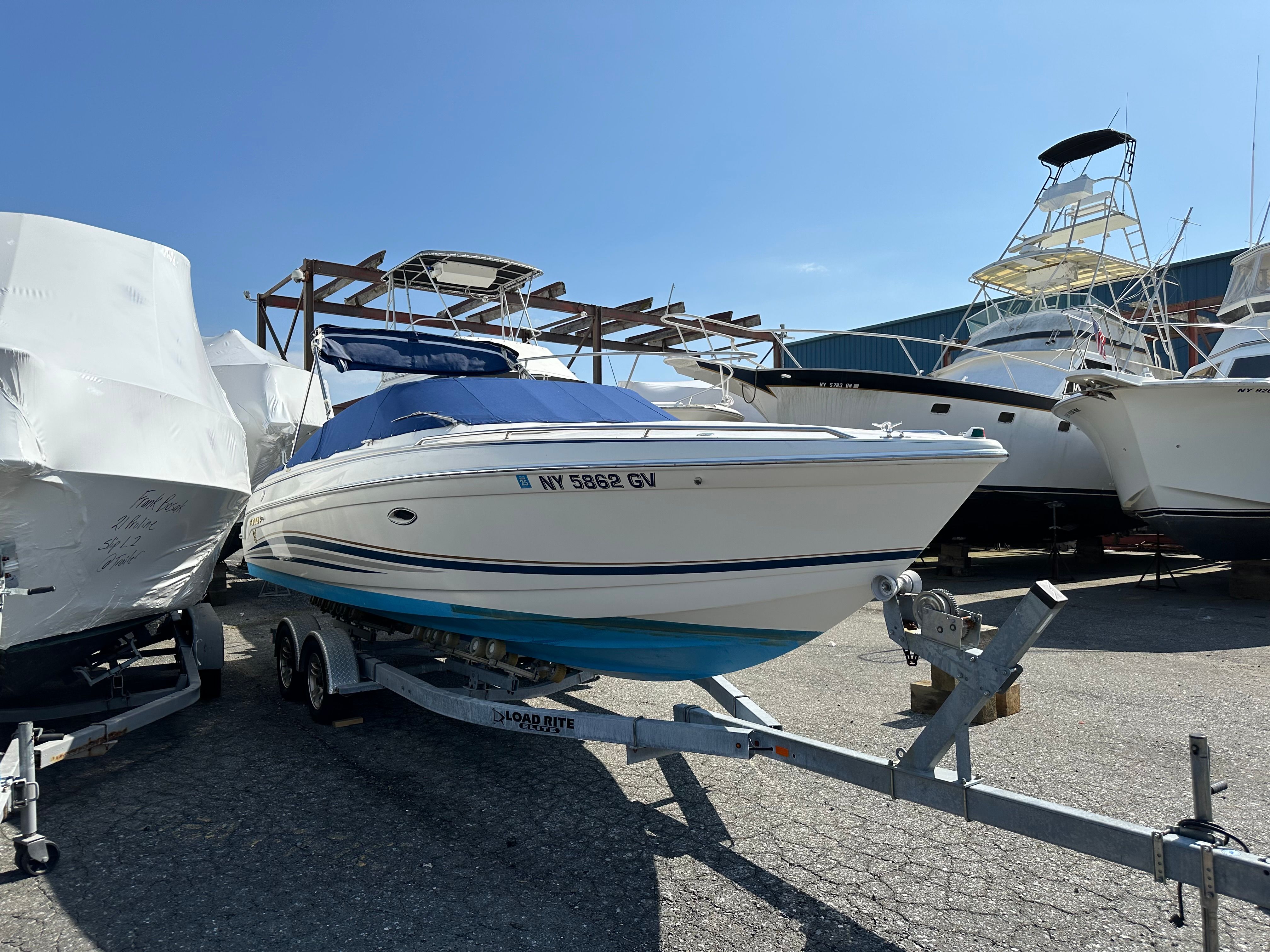 2000 Formula 260 Sun Sport boat on trailer outdoors.