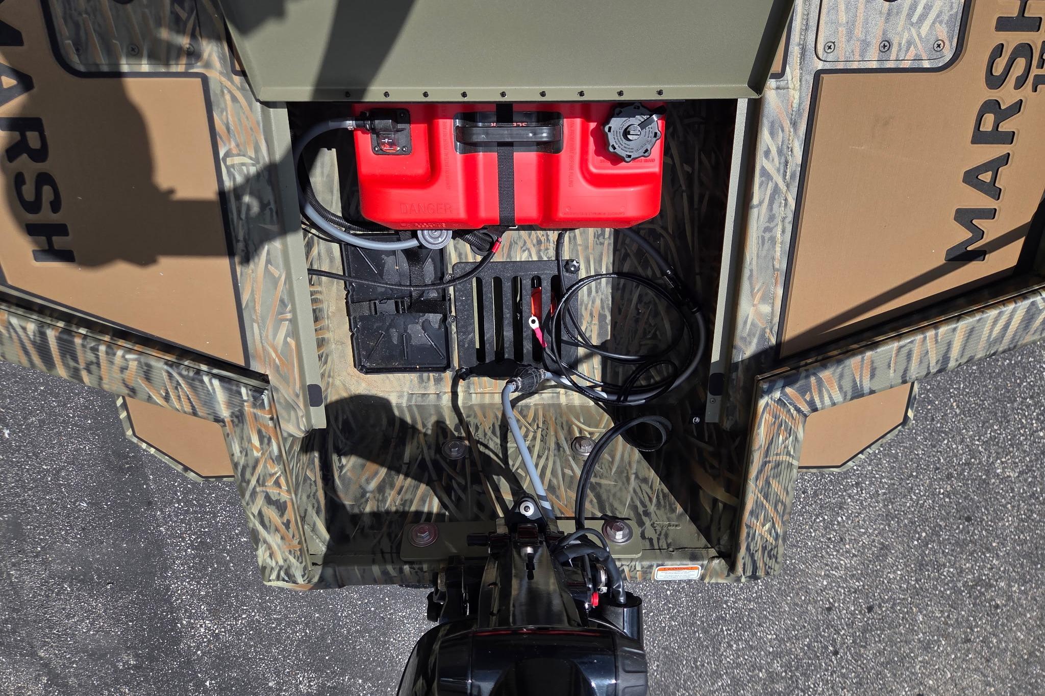 Tracker Grizzly 1756 T Marsh 2026 boat interior with red fuel tank and cables.