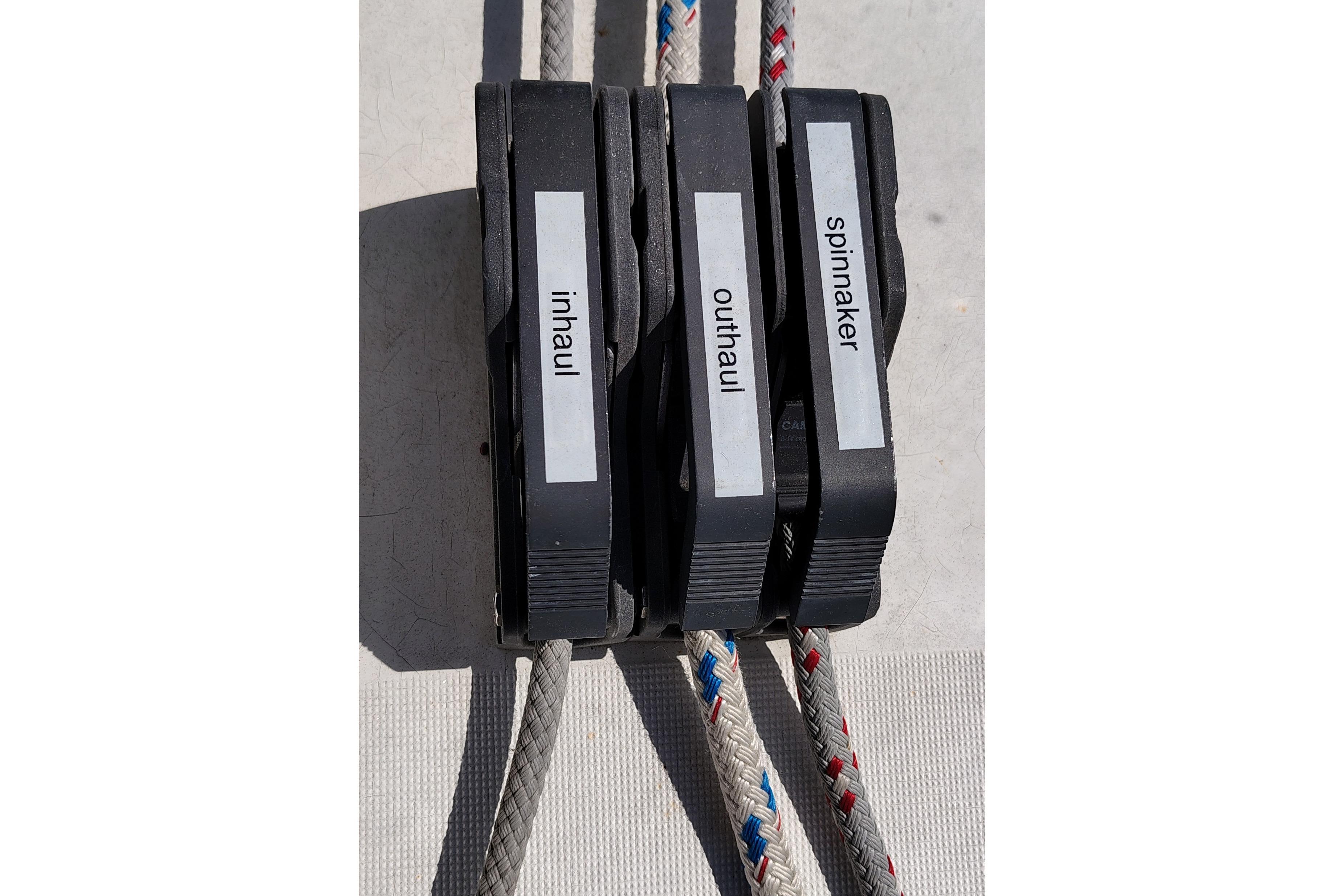 Close-up of labeled rope clutches on a 2001 Beneteau Oceanis 411 sailboat.