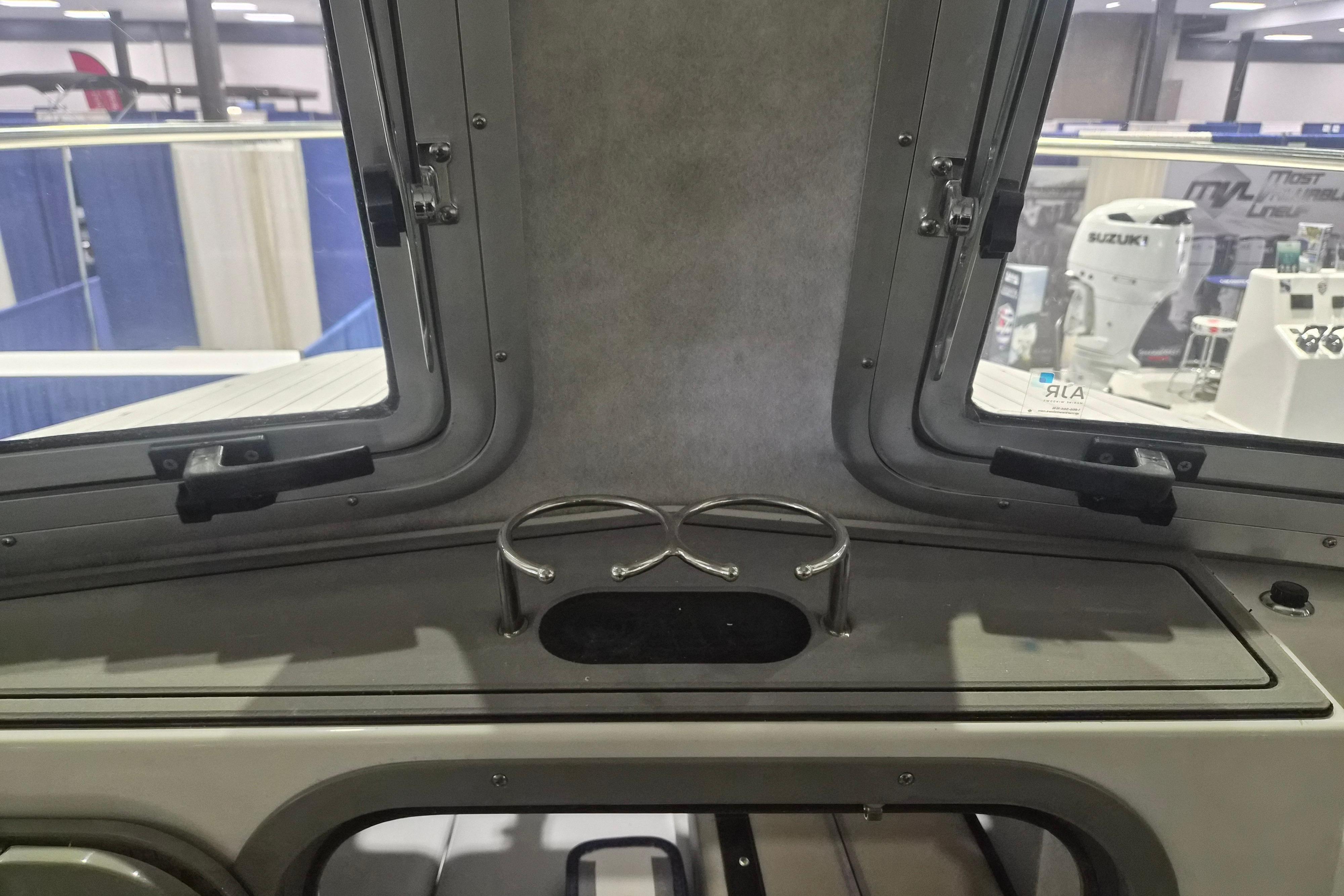 Interior view of 2026 Defiance Admiral 260 EX boat with cup holders and windows.