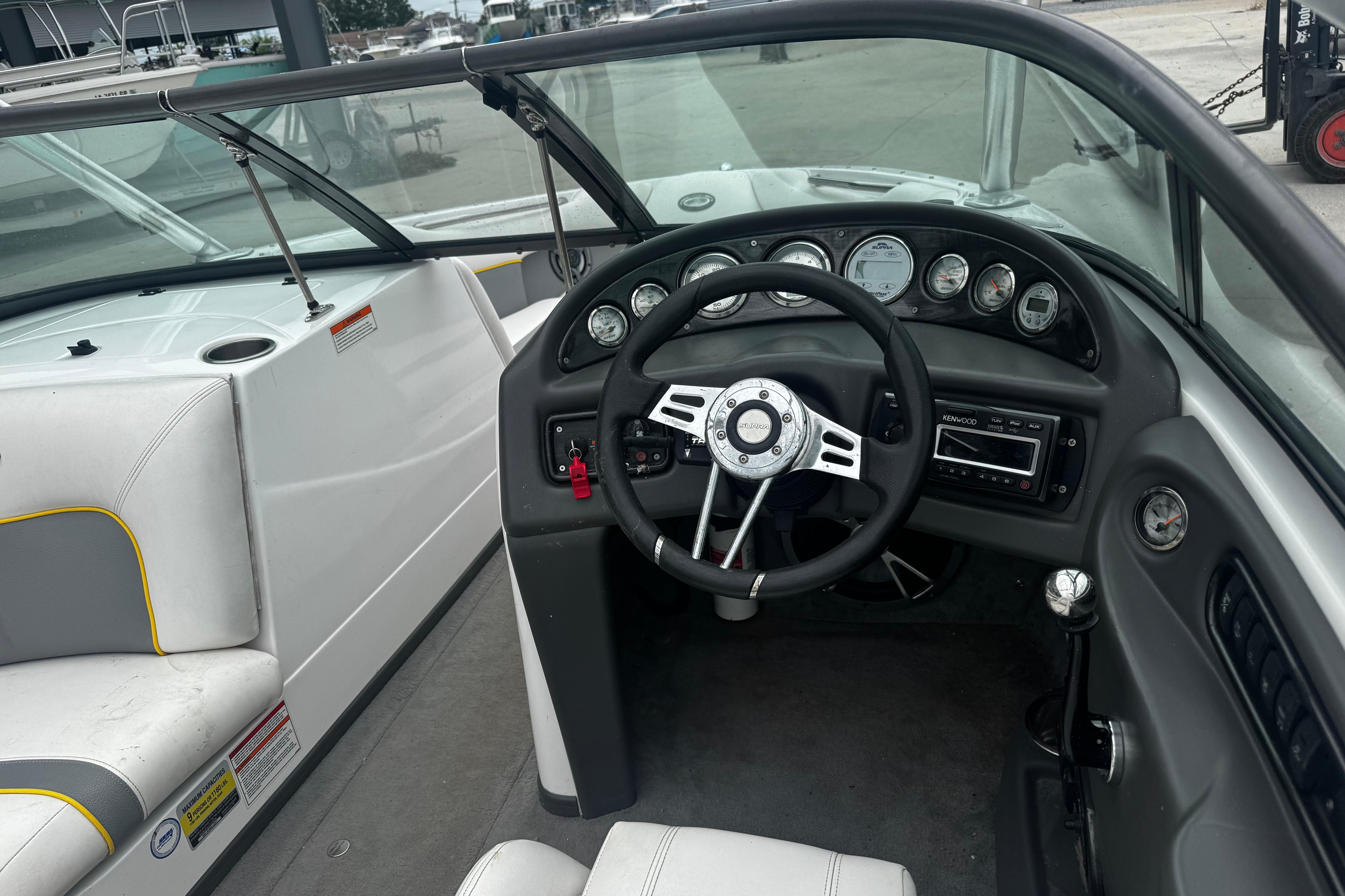 2006 Supra Launch 22 SSV boat interior with steering wheel and dashboard controls.