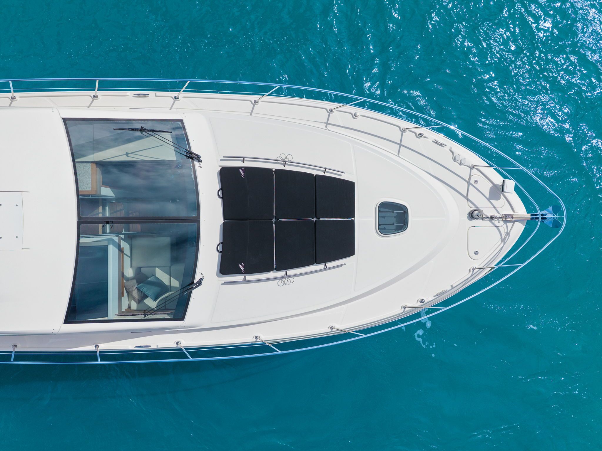 Aerial view of a 2017 Sea Ray Sundancer 510 on clear blue water.