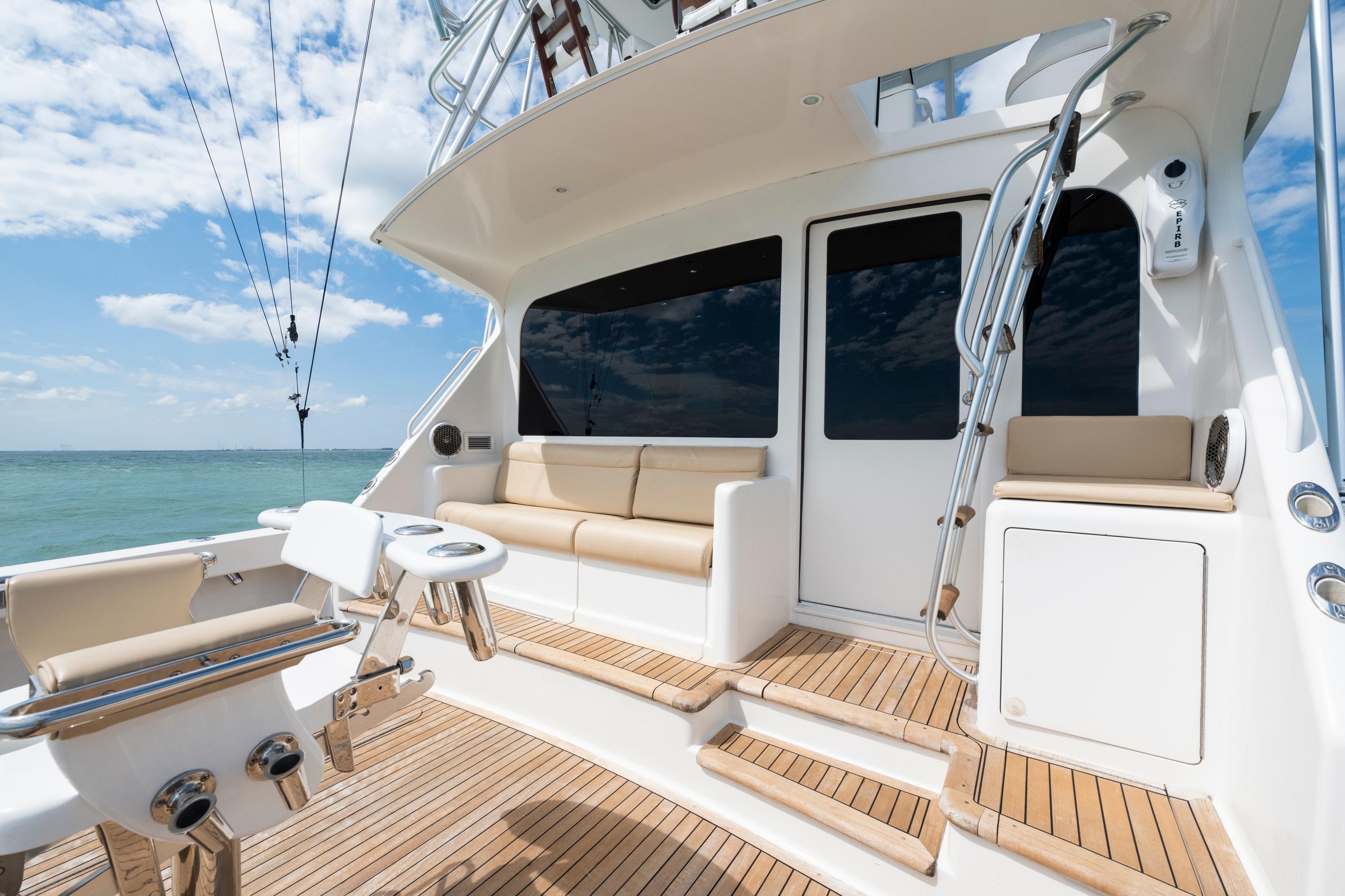 2009 Viking 50 Convertible yacht deck with seating, ocean view, and clear sky.