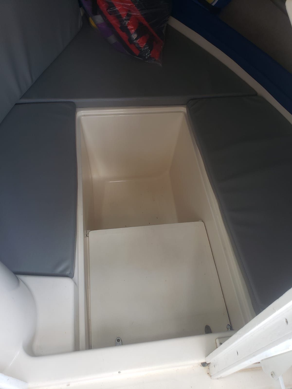 The image shows the interior of a 1995 Grady-White Explorer 24 with cushioned seating areas.