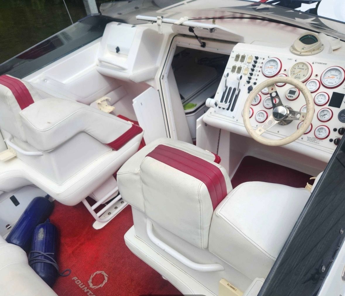 Interior of a 2000 Fountain Fever boat with red carpet.