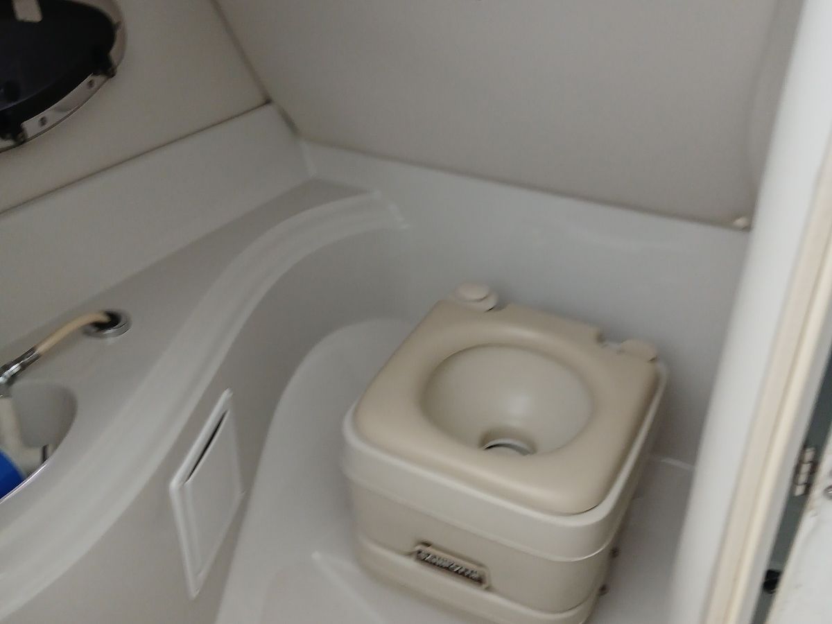 Interior of a 2005 Crownline 220 EX featuring a portable toilet.