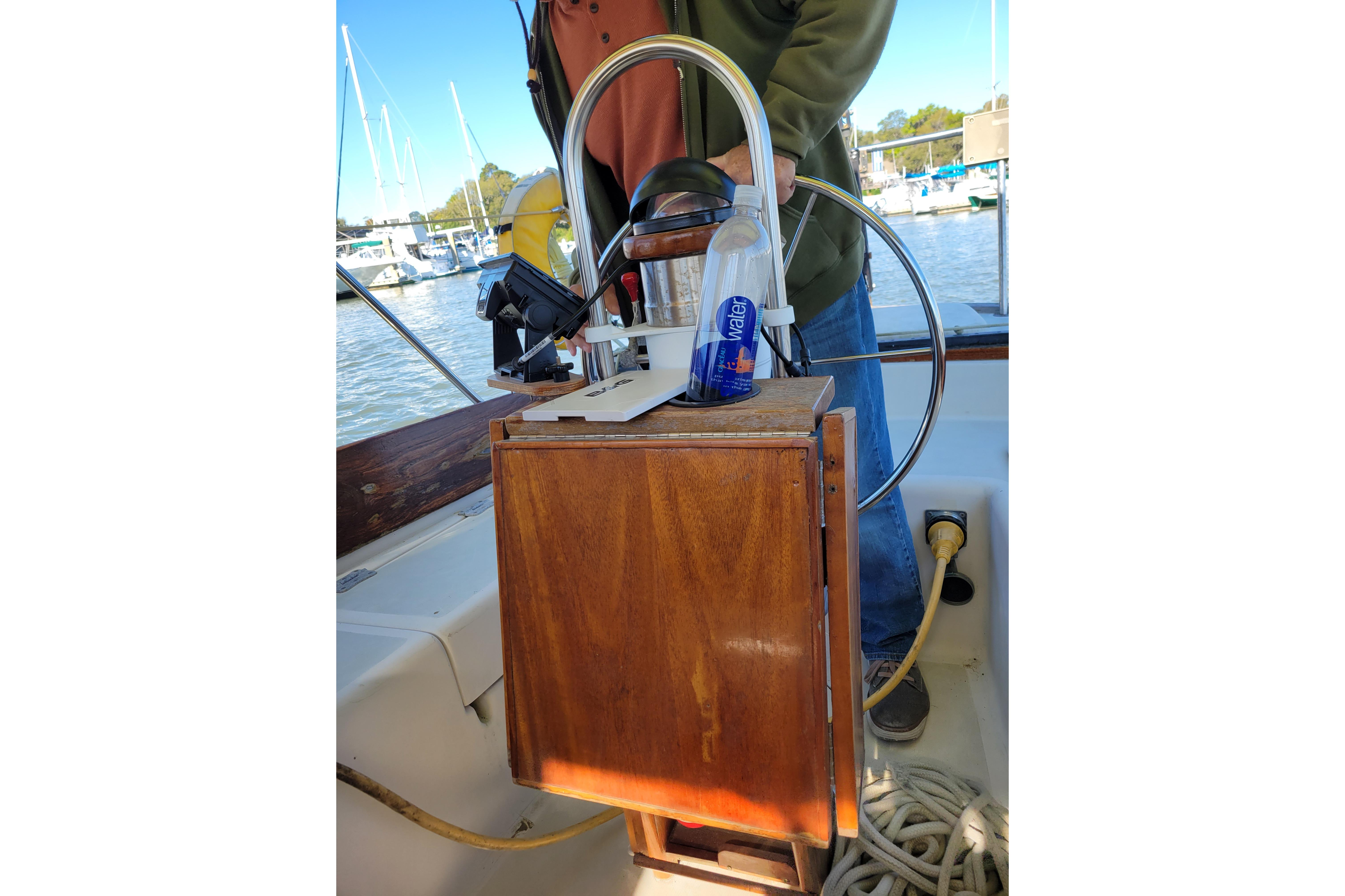 1981 Sea Sprite 34 sailboat cockpit with steering wheel and wooden panel.