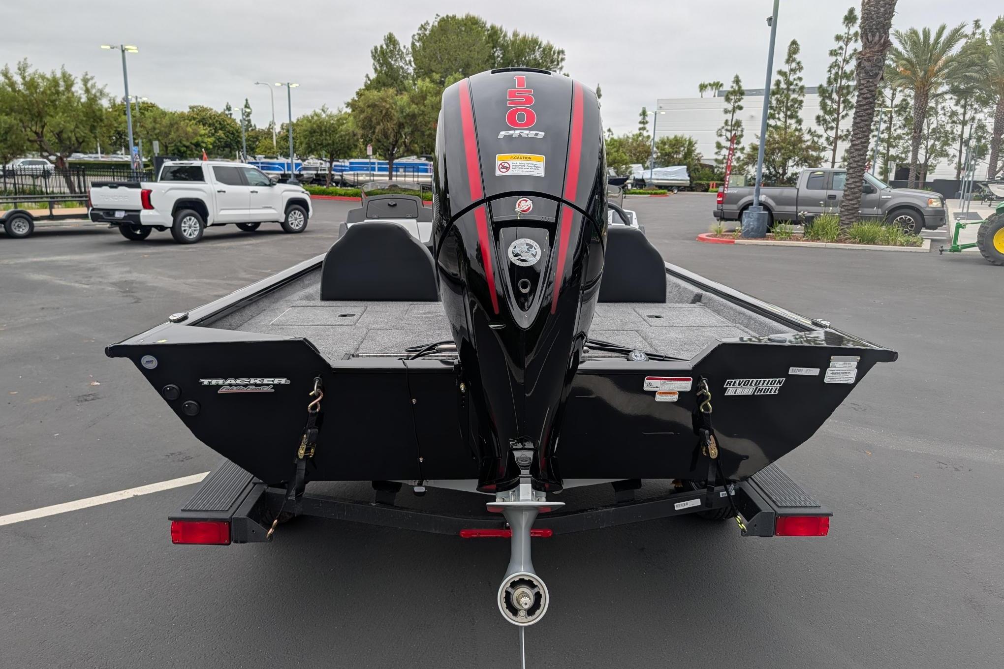 2026 Tracker Pro Team 195 TXW boat with powerful 150 HP engine, parked outdoors.