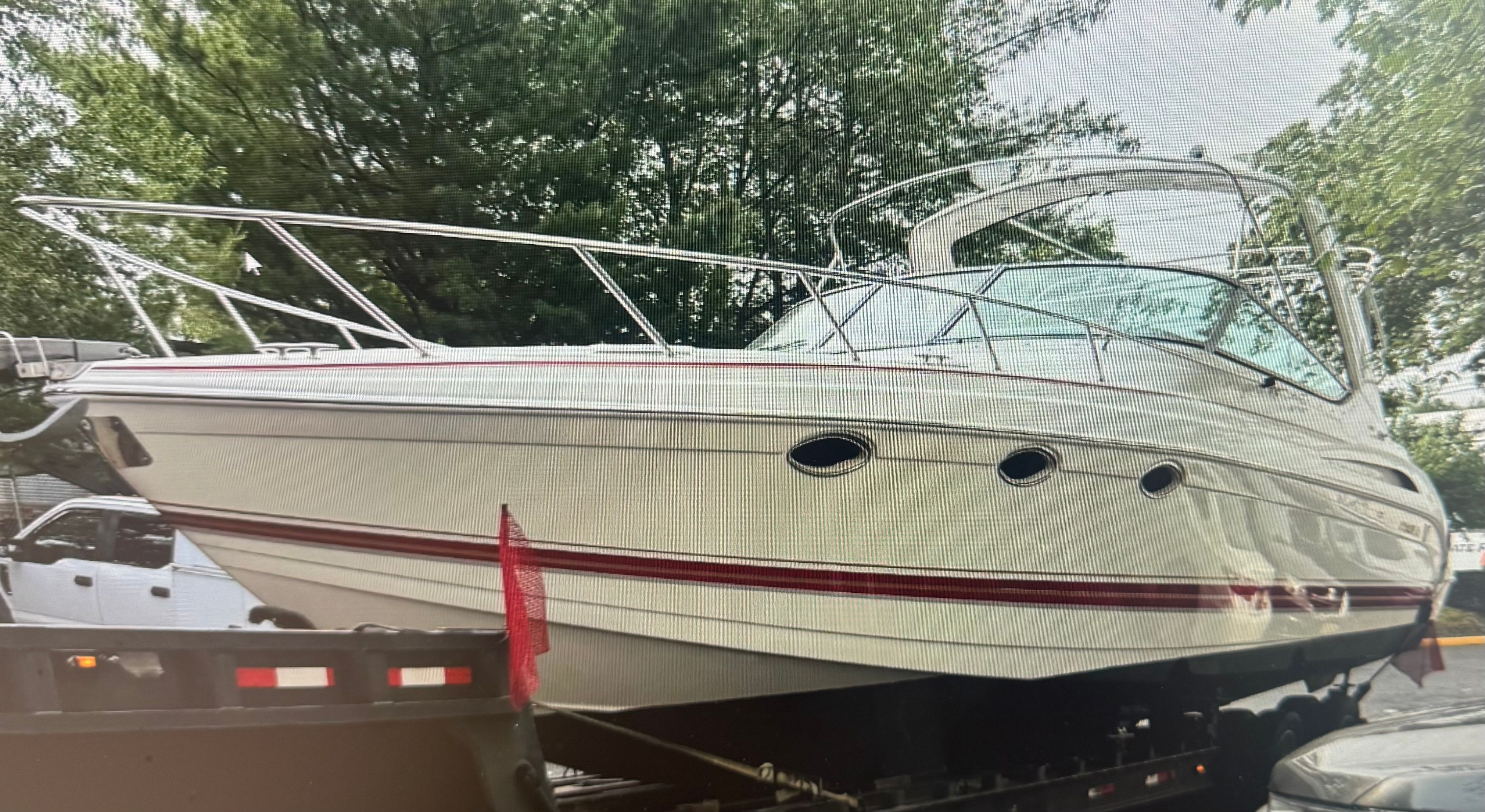 2001 Formula 37 Super Sport boat on trailer outdoors.