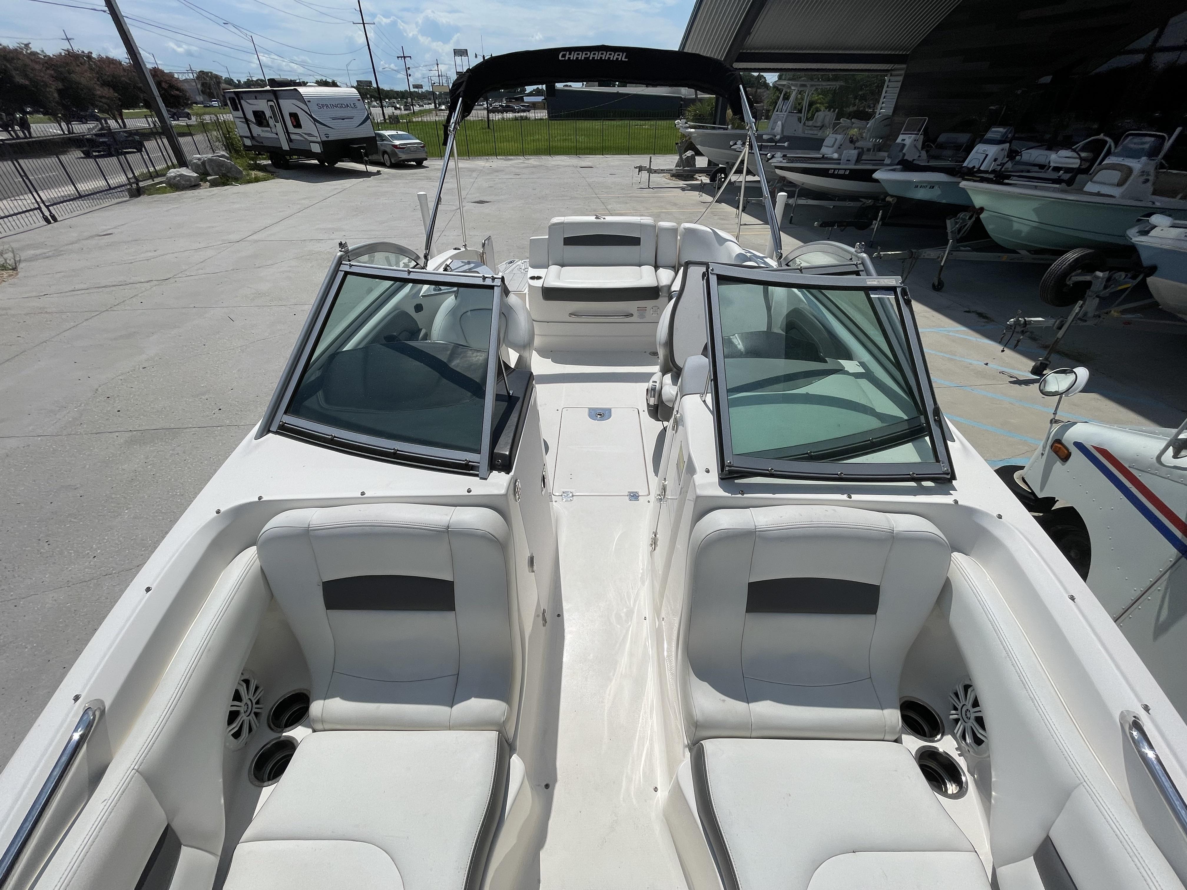 2014 Chaparral Sunesta 224 boat interior with white seating and open windshield.