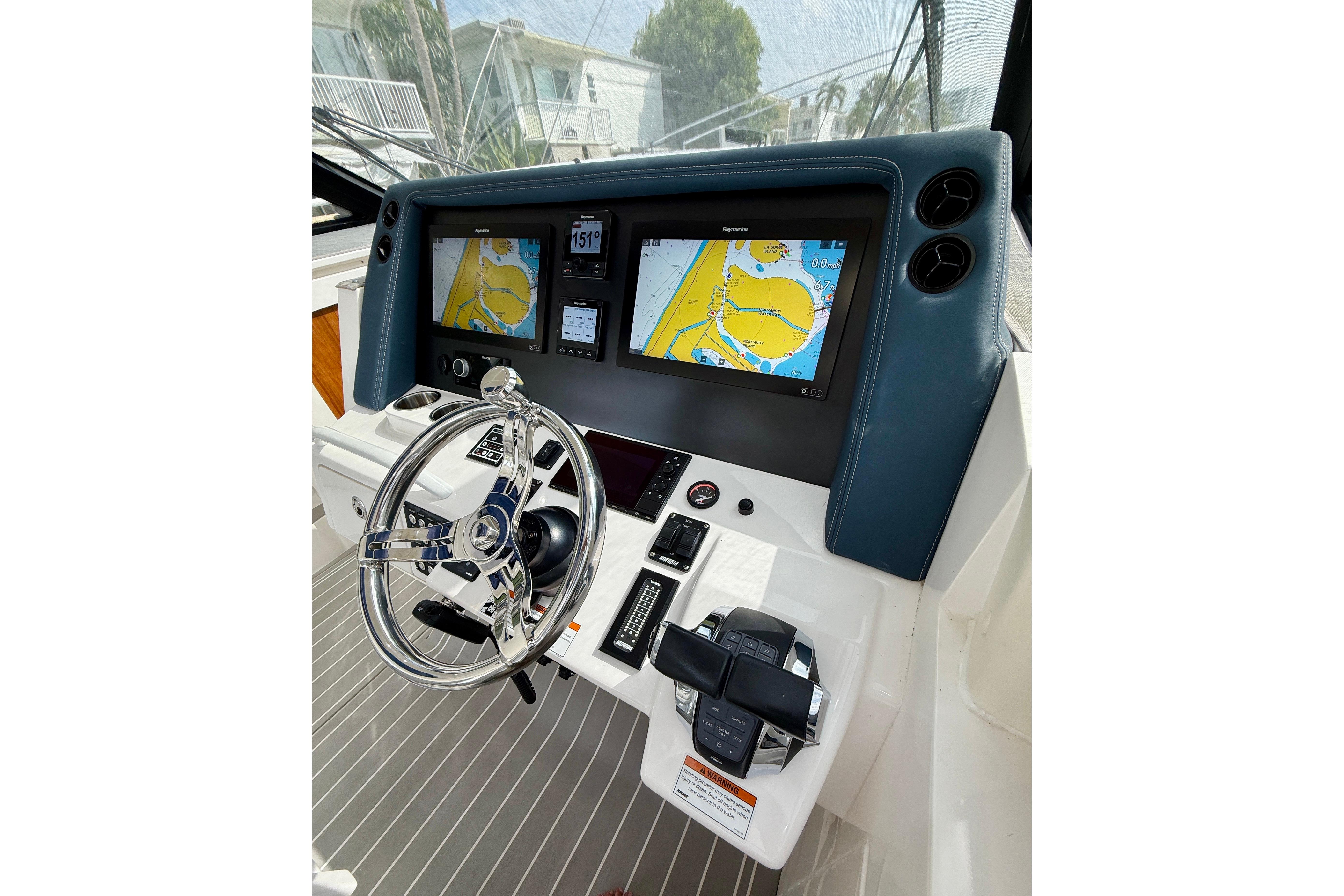 2021 Intrepid 410 Evolution helm with dual navigation screens and modern steering wheel.