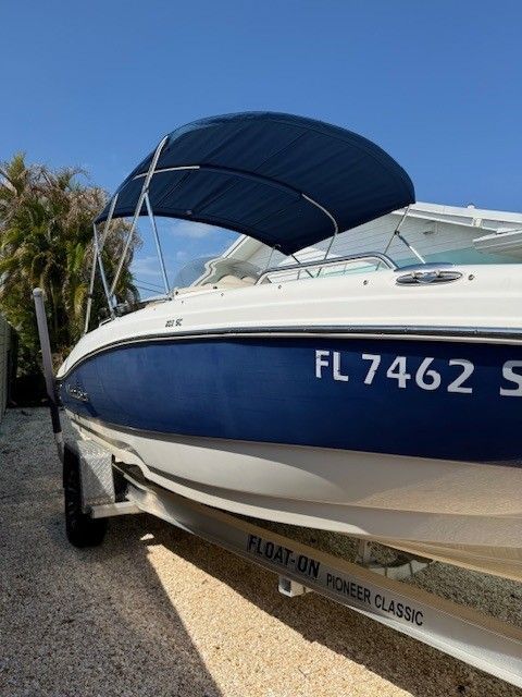 2020 Nautic 203SC boat with blue canopy on trailer.