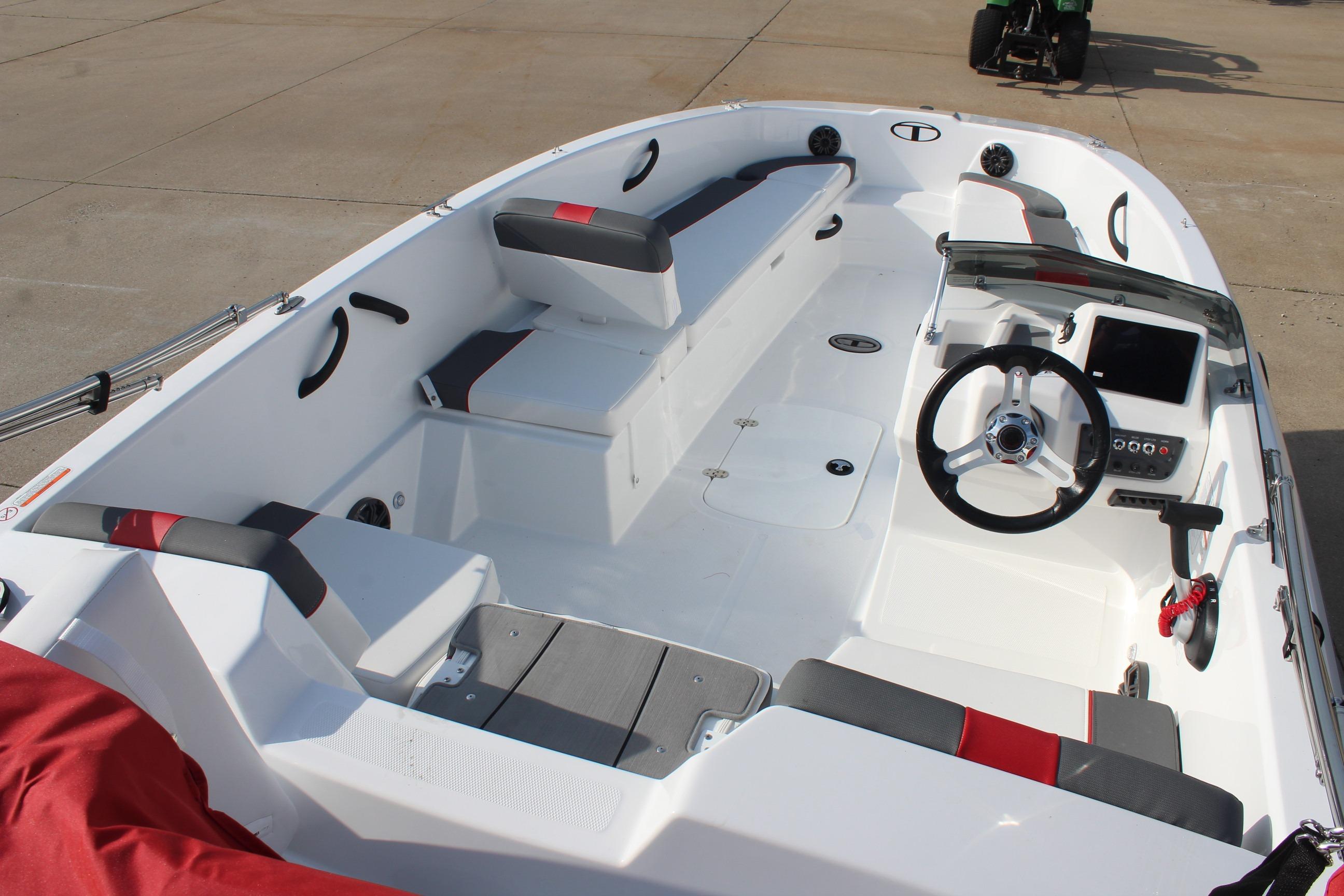 2026 Tahoe T18 boat interior with steering wheel, seating, and control panel.