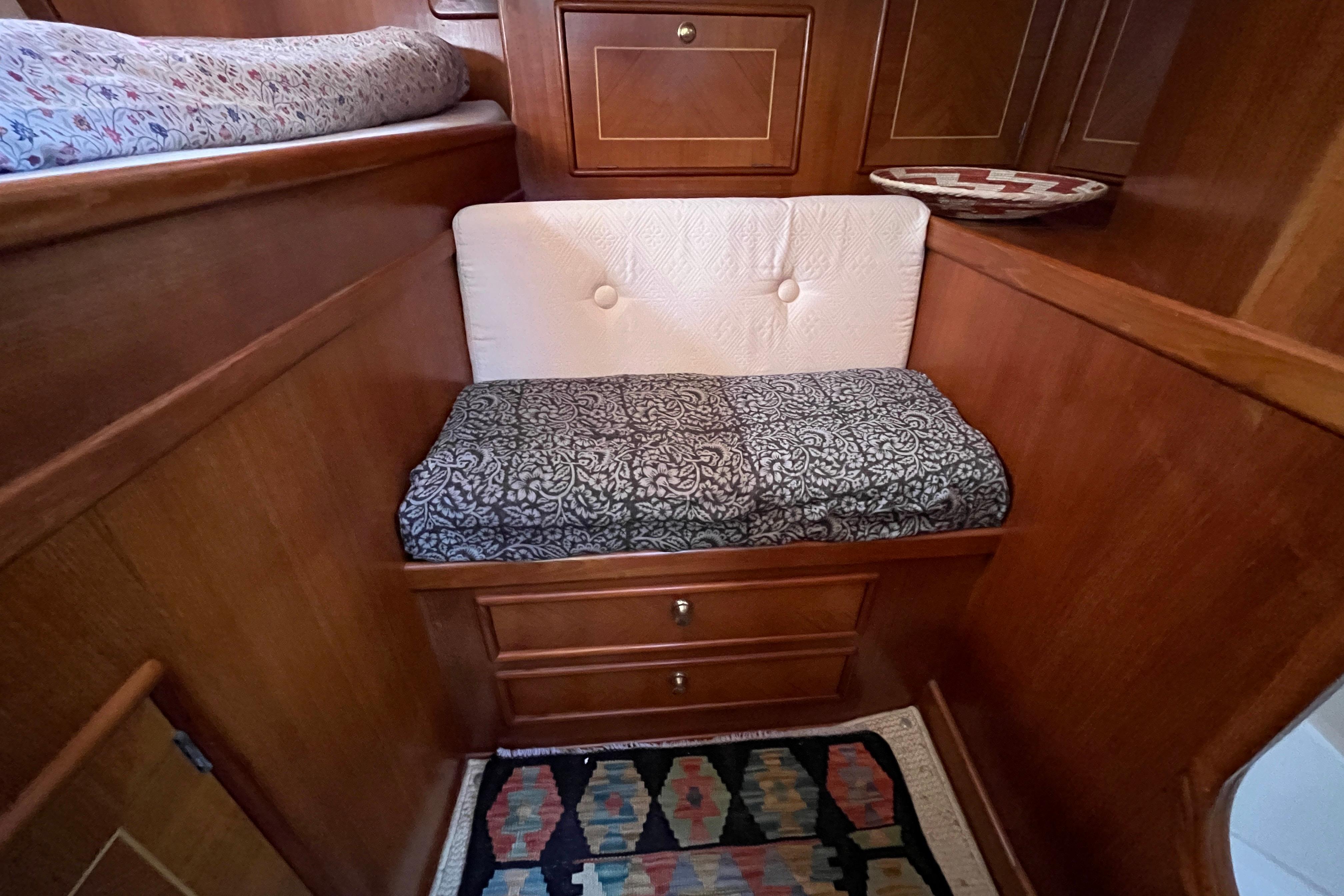 Cozy seating area with patterned cushions in a 1995 Belliure 41 yacht interior.