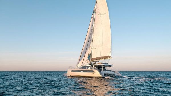 Luxury Privilege Signature 580 catamaran sailing on open sea, 2025 model.