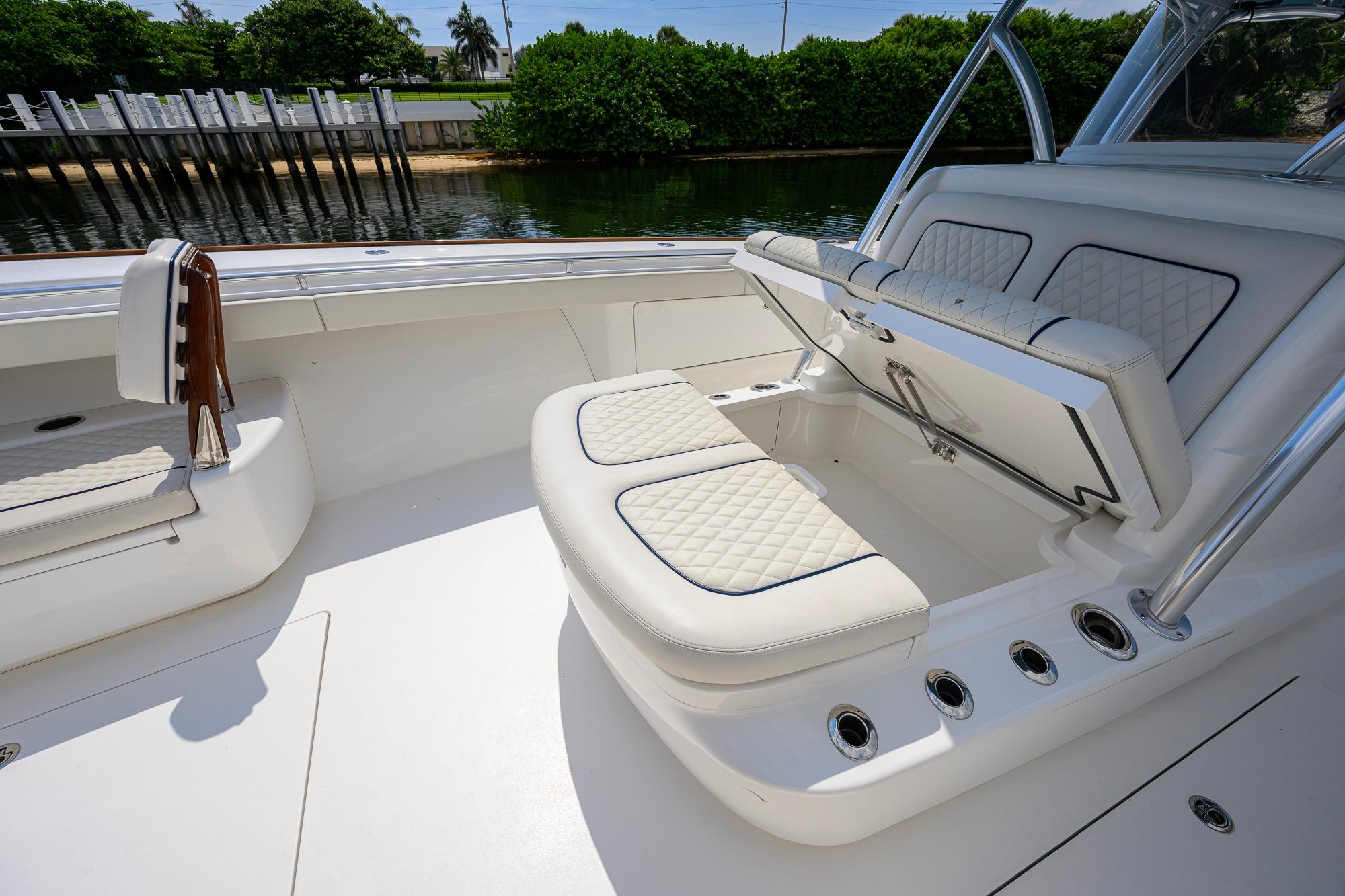2020 Valhalla Boatworks V-41 interior with cushioned seating and storage compartment.