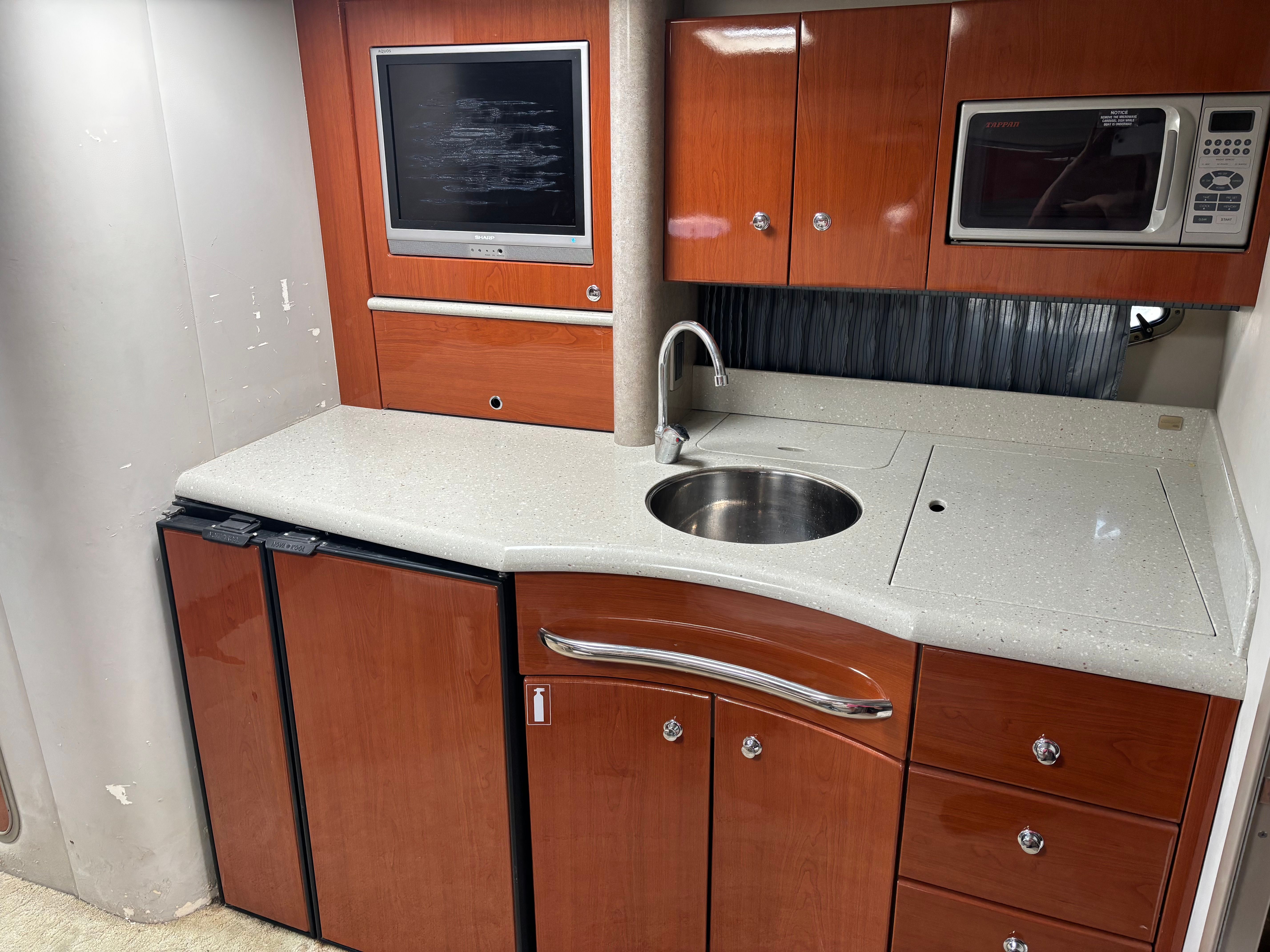 Interior galley area with sink, microwave, and refrigerator.